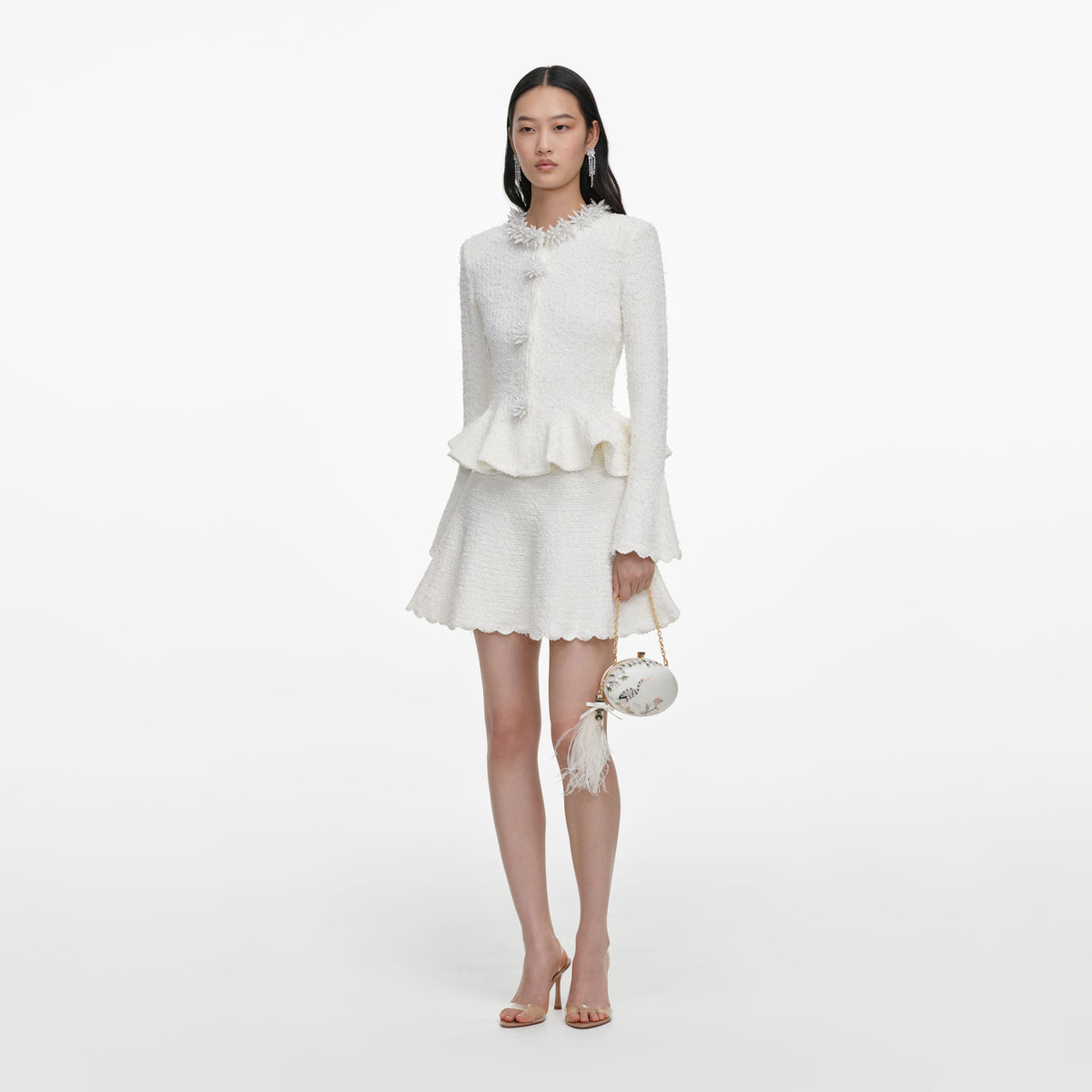 Side view of a woman wearing the White Textured Knit Mini Dress