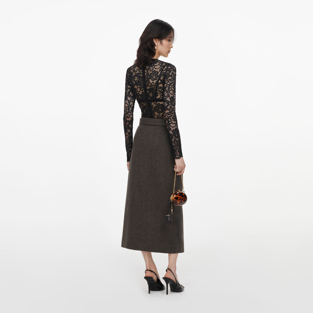 Back view of a woman wearing the Brown Wool Midi Skirt