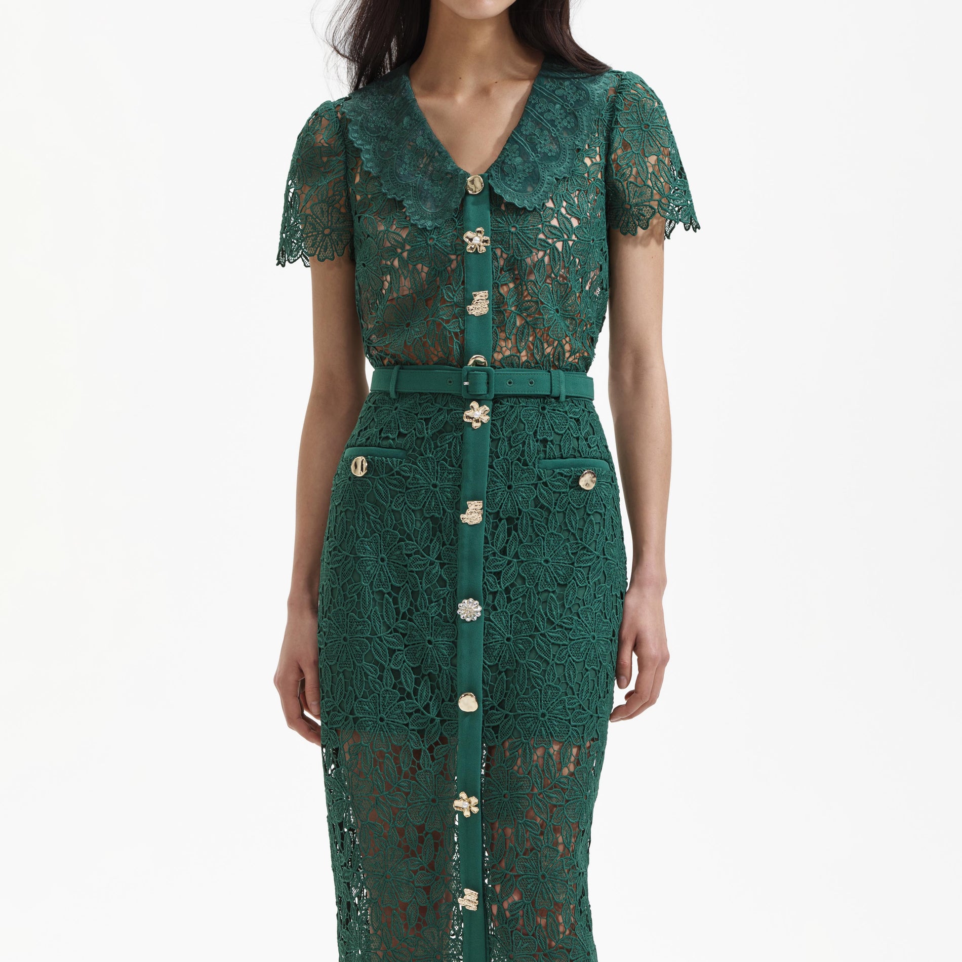 A close up of a woman wearing the Green Guipure Lace Top