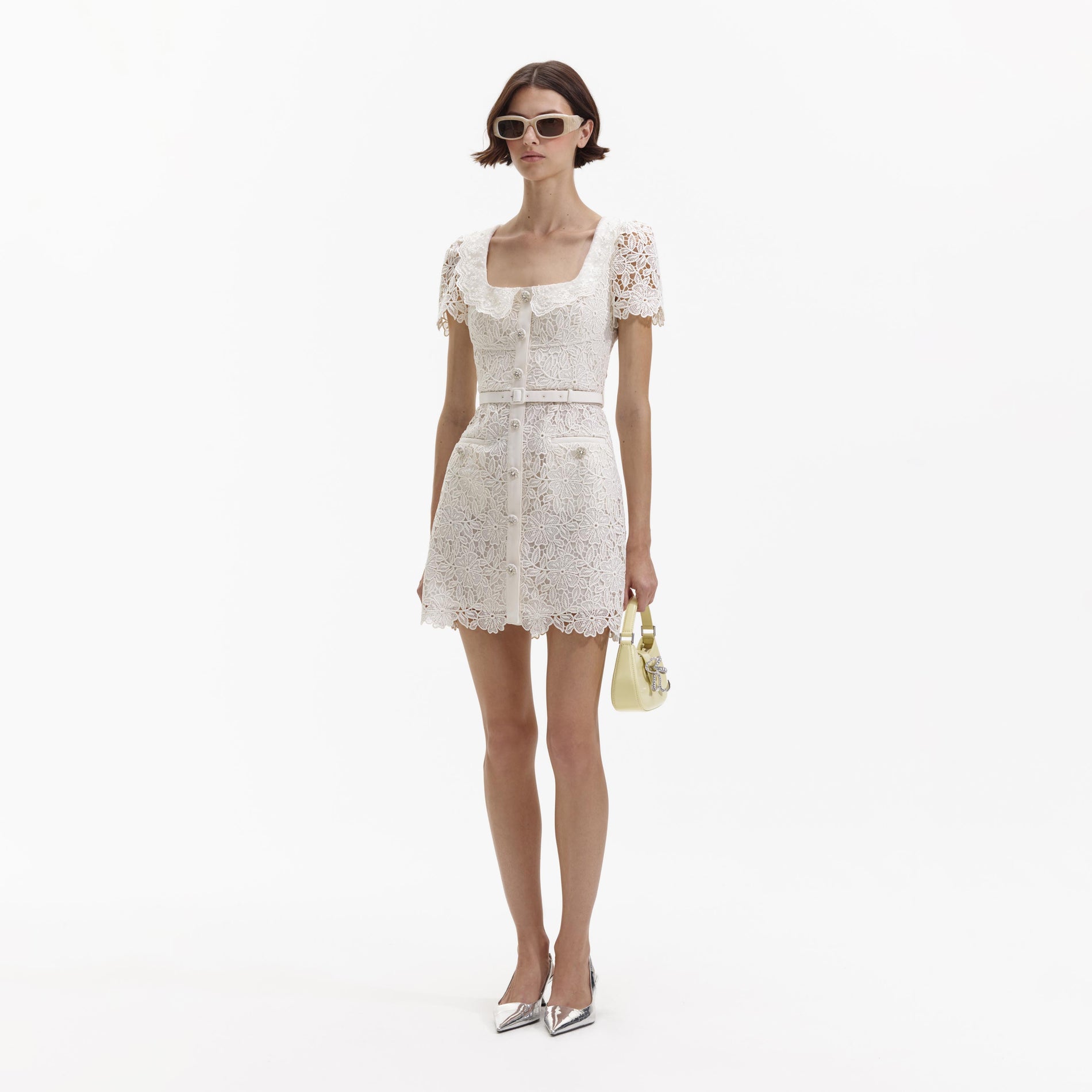 Side view of a woman wearing the Cream Guipure Lace Button Mini Dress