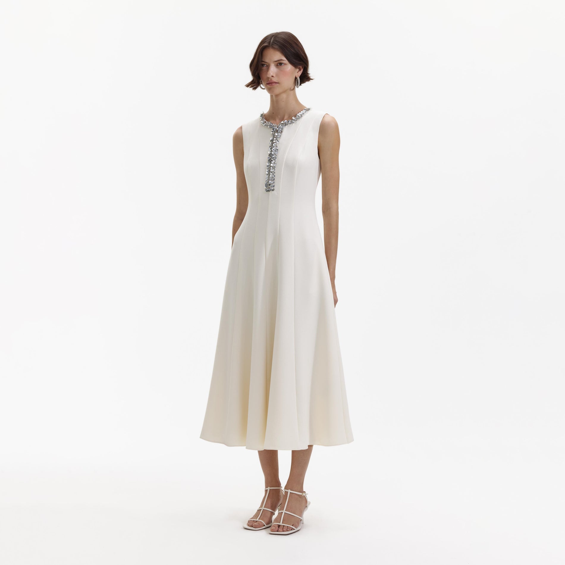 Side view of a woman wearing the Cream Crepe Embellished Midi Dress