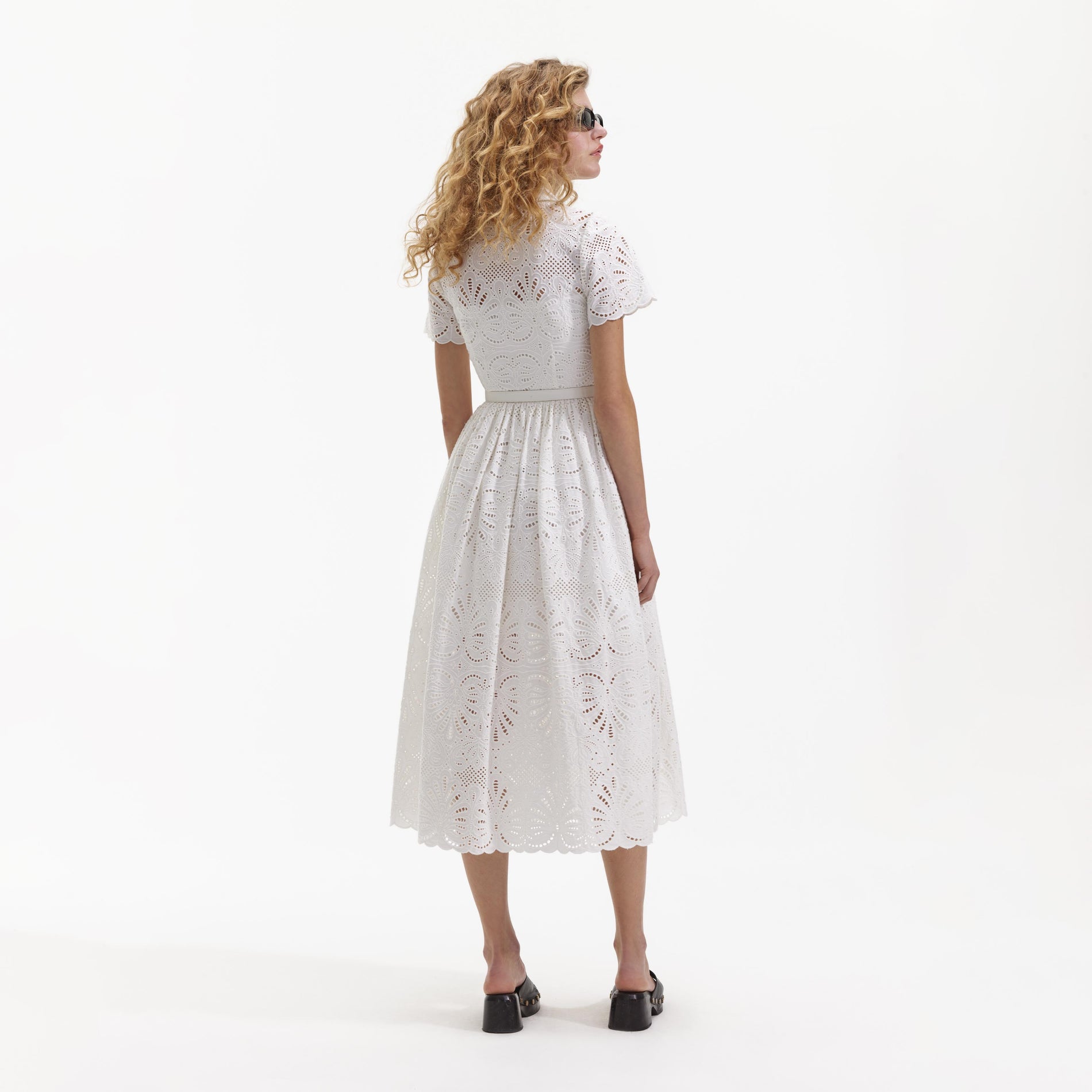 Back view of a woman wearing the White Cotton Embroidery Midi Dress