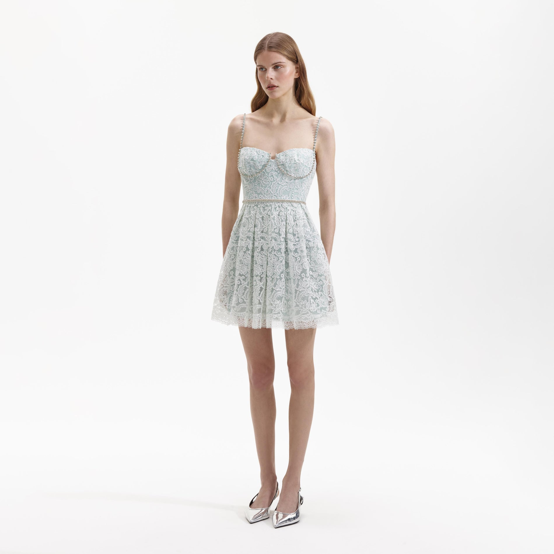 Side view of a woman wearing the Green Cord Lace Mini Dress