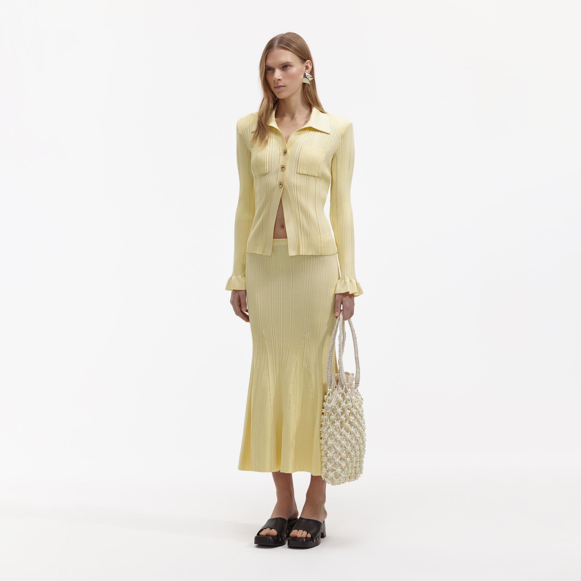 Side view of a woman wearing the Yellow Ribbed Viscose Knit Top
