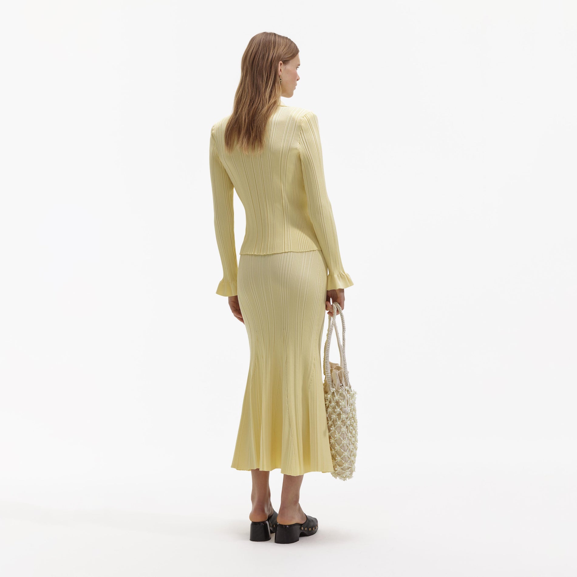 Back view of a woman wearing the Yellow Ribbed Viscose Knit Top