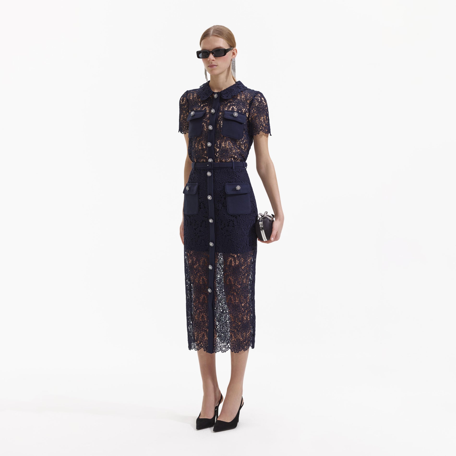 Side view of a woman wearing the Navy Guipure Lace Top