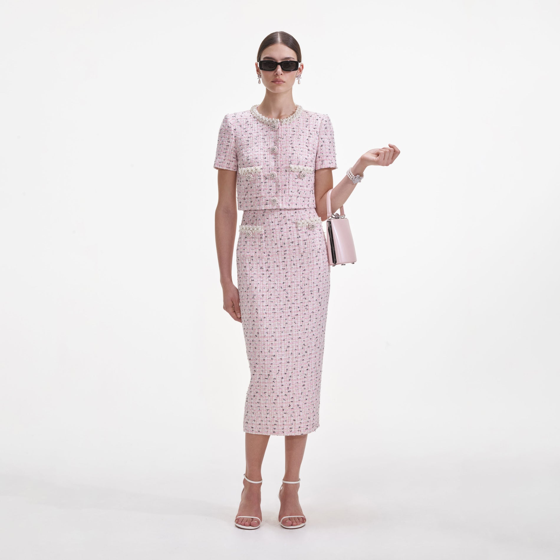 Front view of a woman wearing the Pink Boucle Pearl Midi Skirt