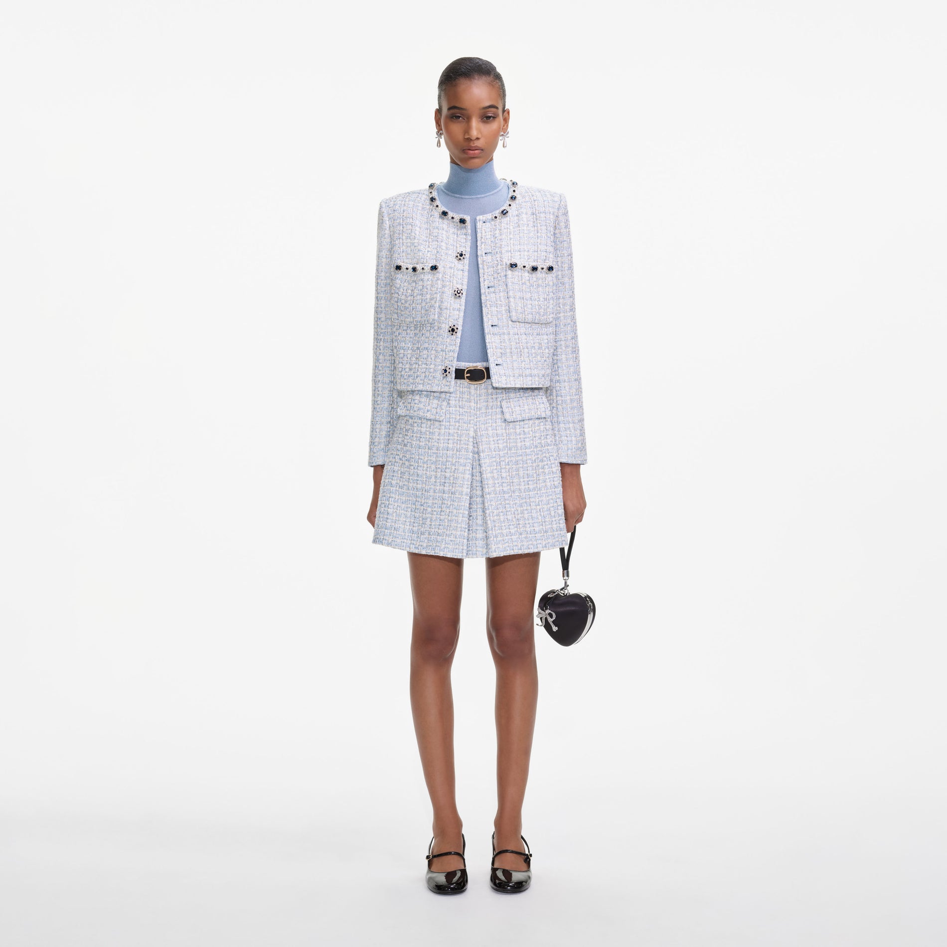 Front view of a woman wearing the Blue Boucle Mini Skirt