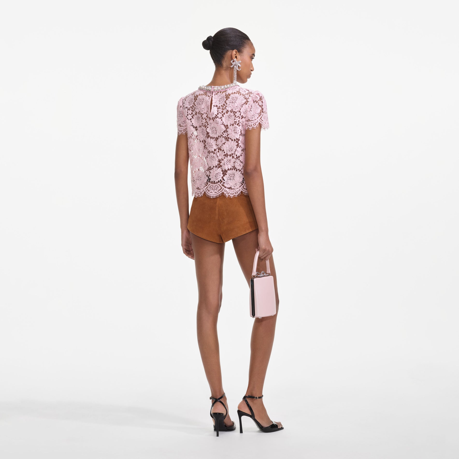 Back view of a woman wearing the Pink Lace Top