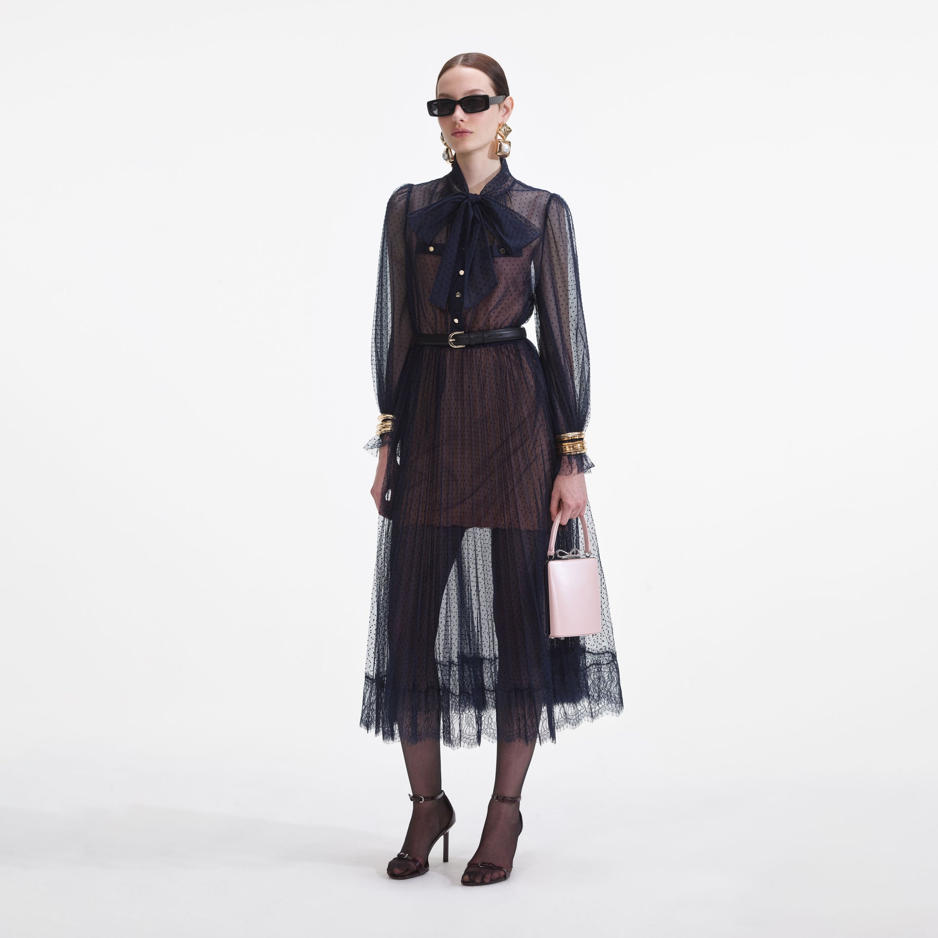 Side view of a woman wearing the Navy Dot Mesh Midi Dress