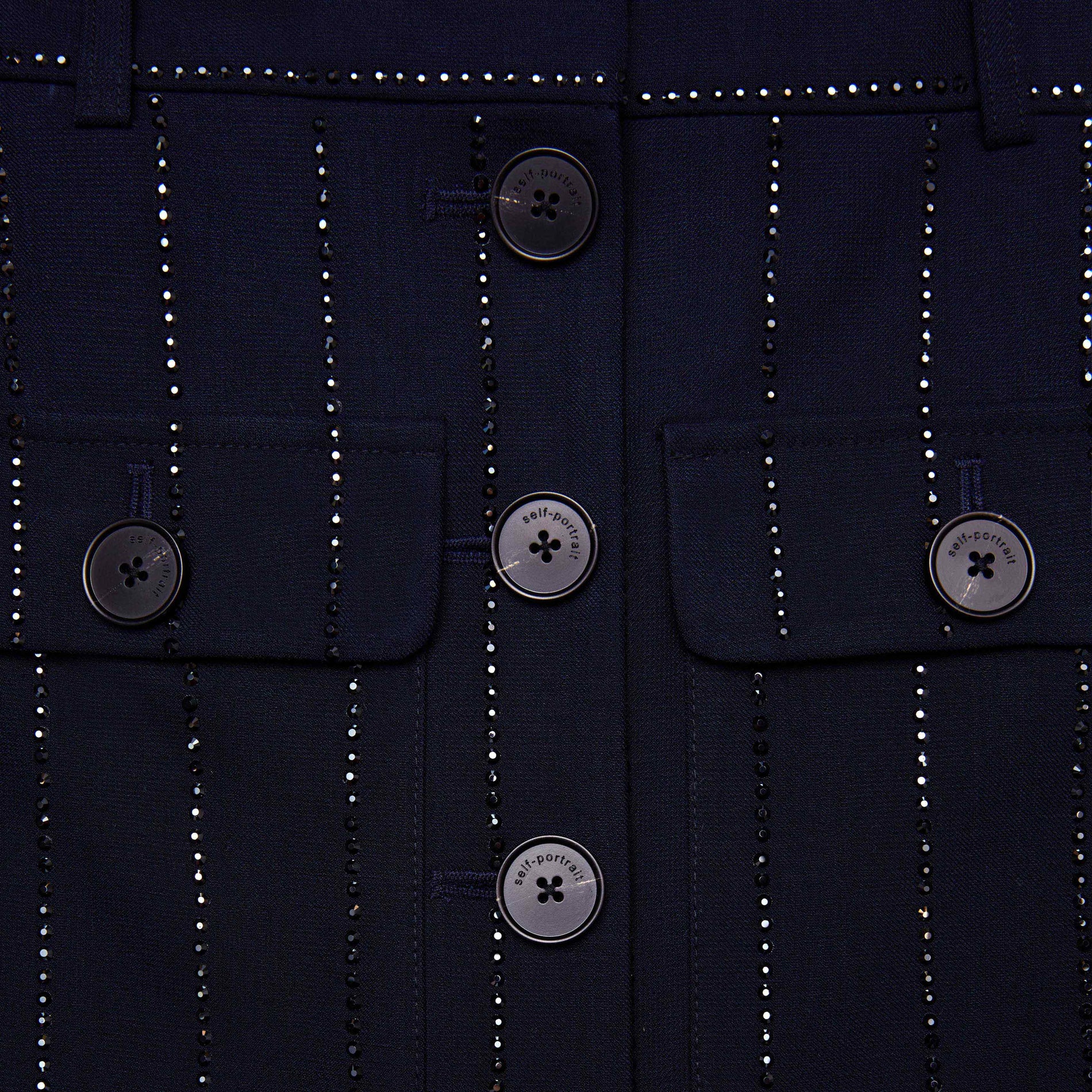 Side view of a woman wearing the Navy Rhinestone Pinstripe Midi Skirt