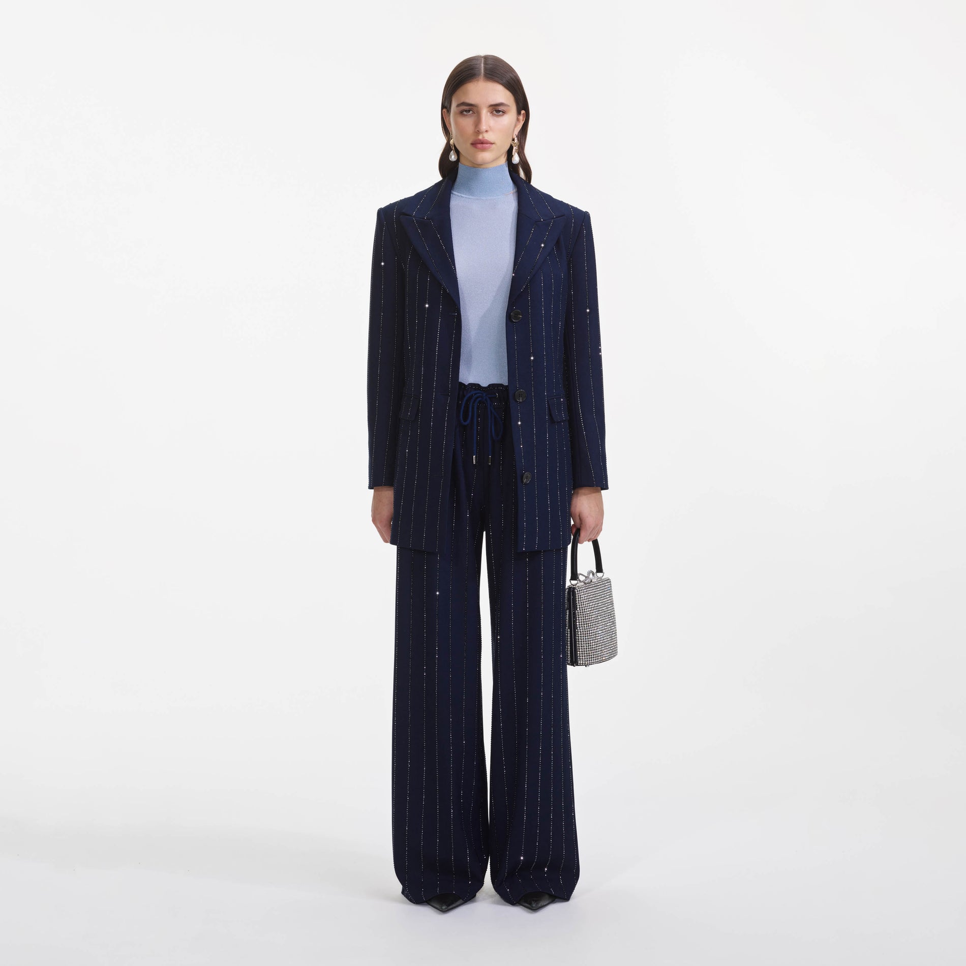 Front view of a woman wearing the Navy Rhinestone Pinstripe Trousers