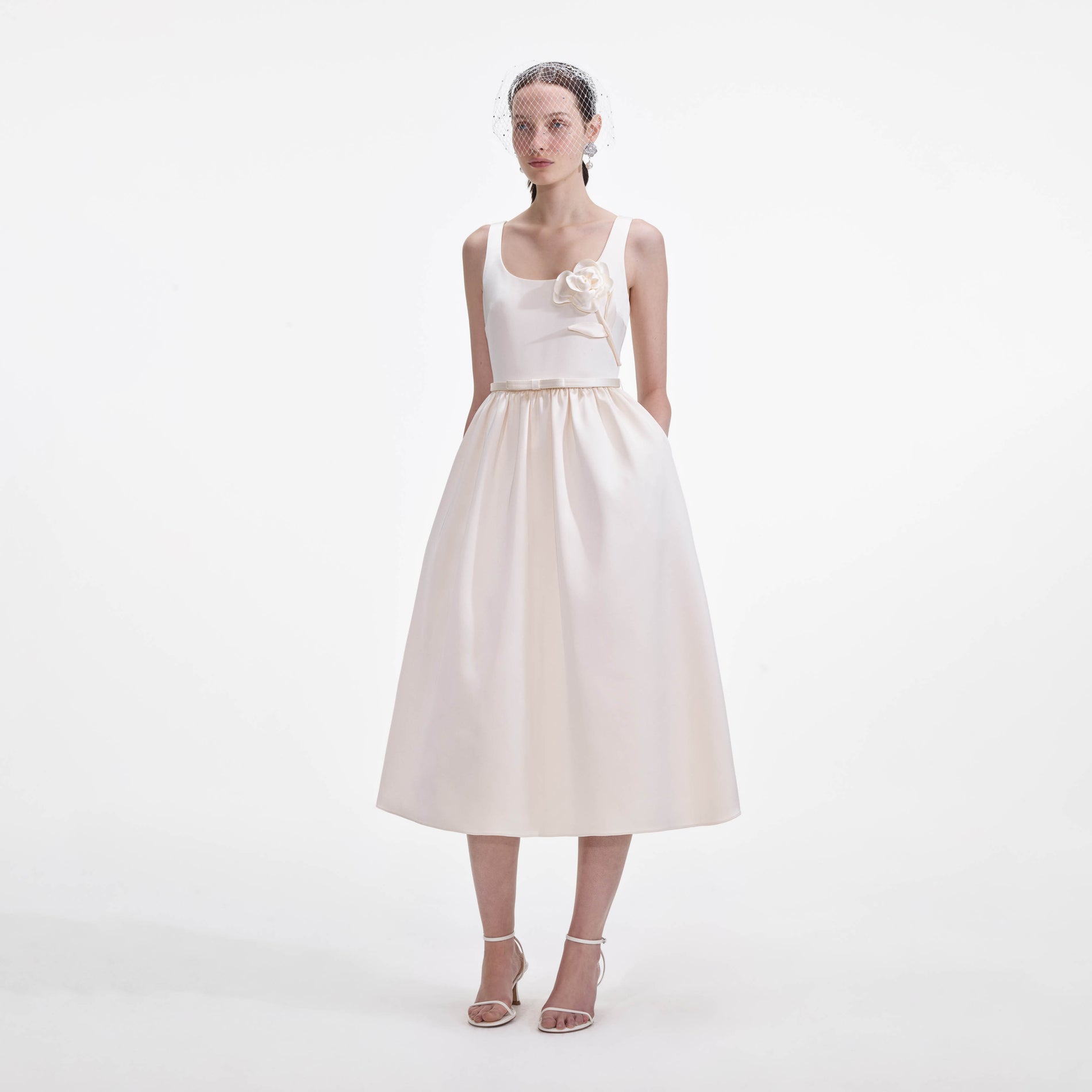 Side view of a woman wearing the Cream Satin Flower Midi Dress