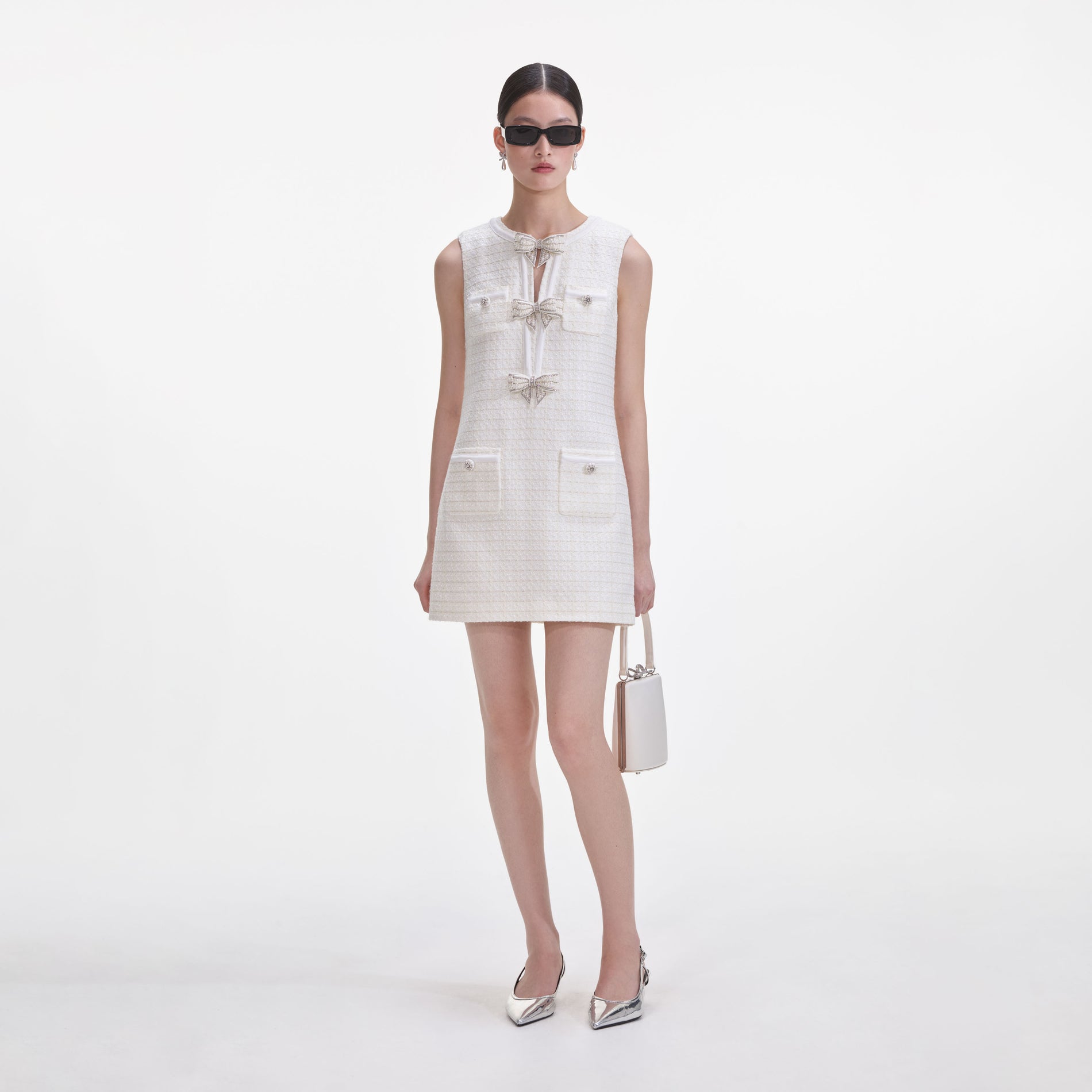 Front view of a woman wearing the Cream Boucle Bow Mini Dress