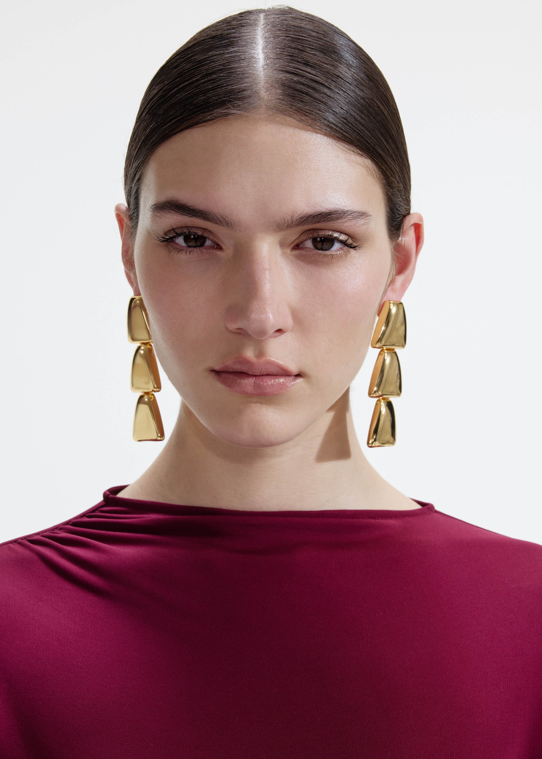 A photo of the Gold Tiered Bell Earrings