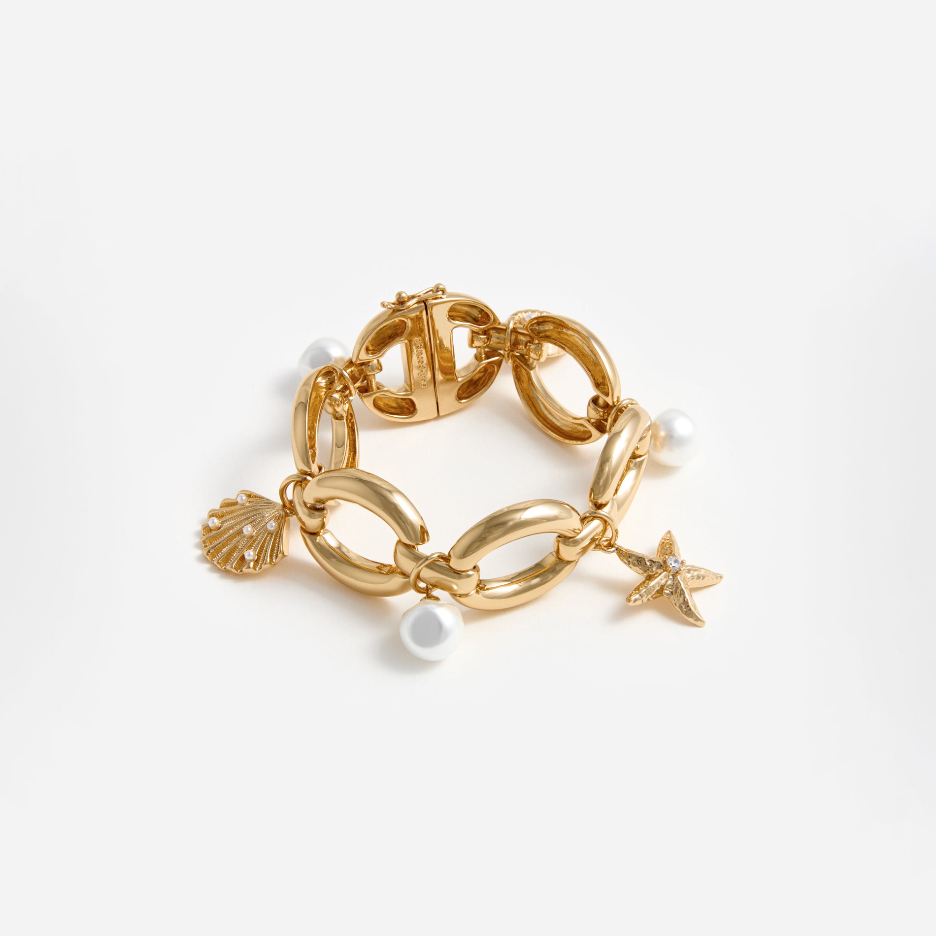 A photo of the Gold Pearl Shell Charm Bracelet