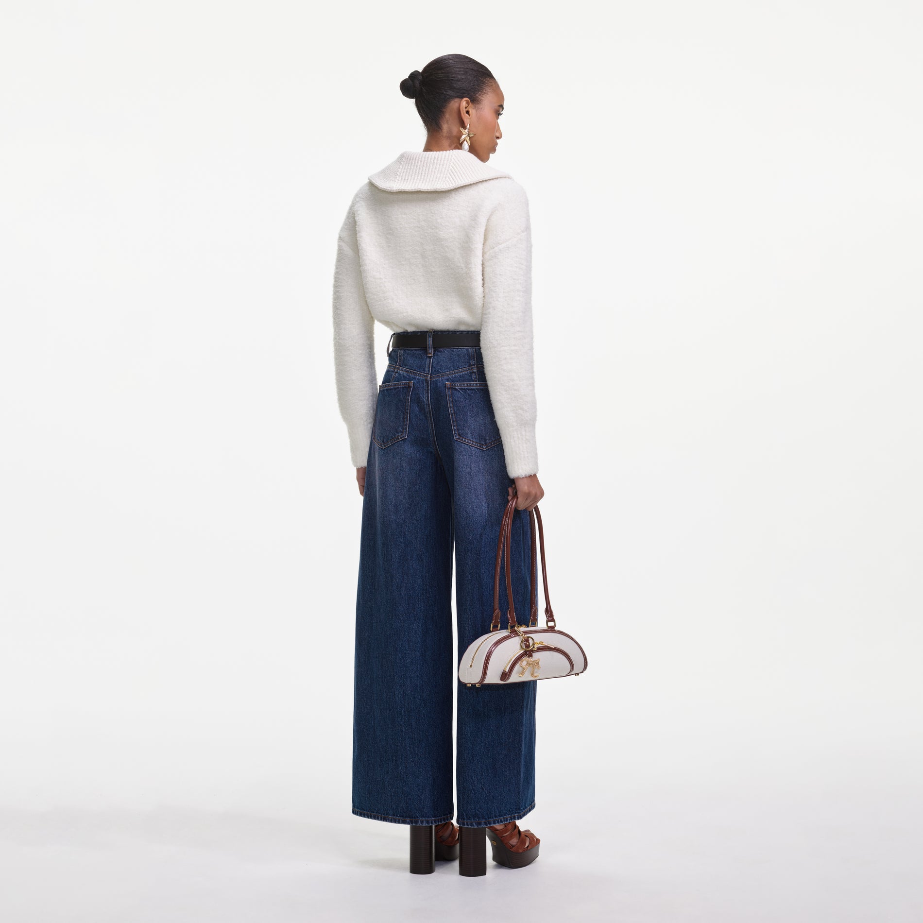 Back view of a woman wearing the Bleached Denim Jeans