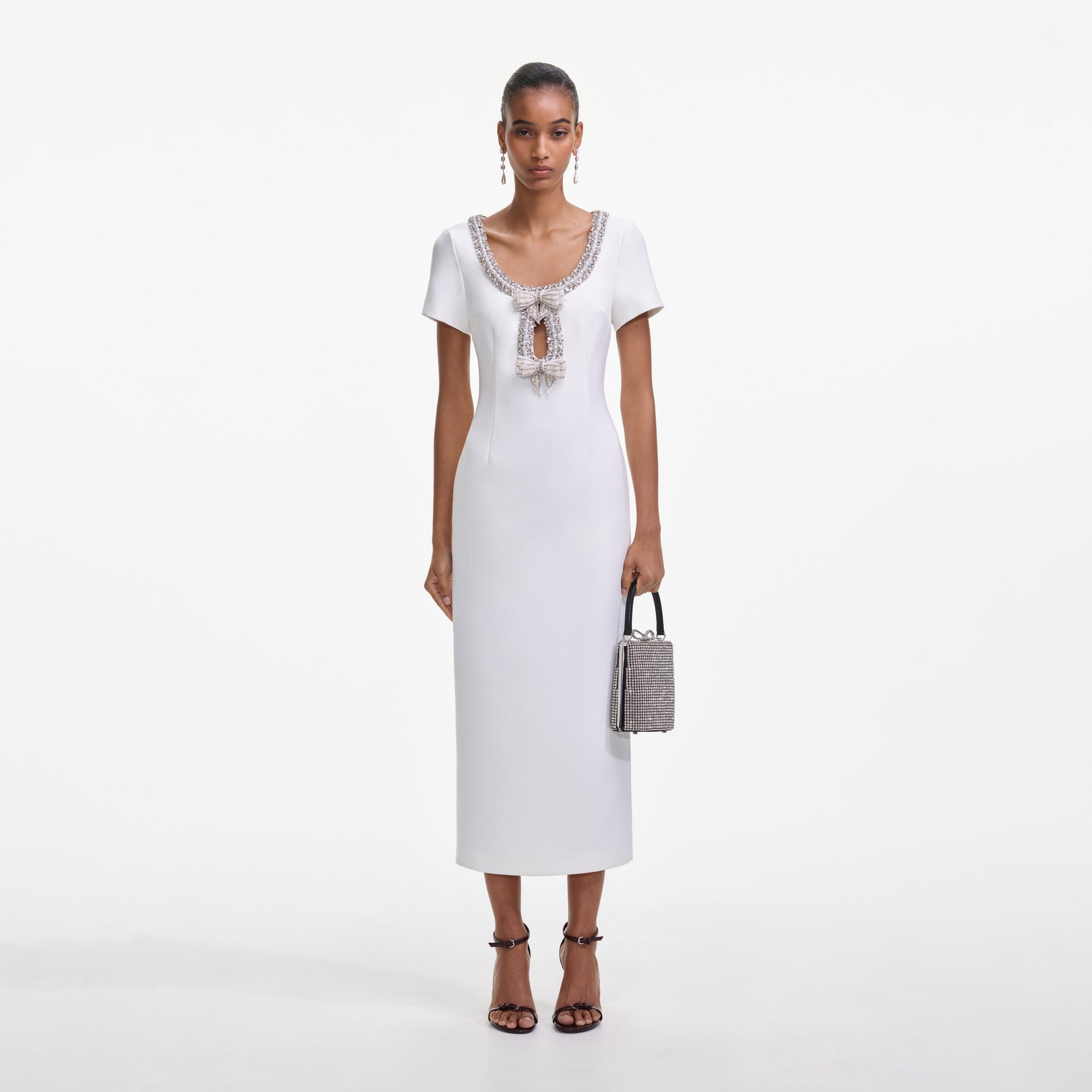 Front view of a woman wearing the White Crepe Bow Midi Dress