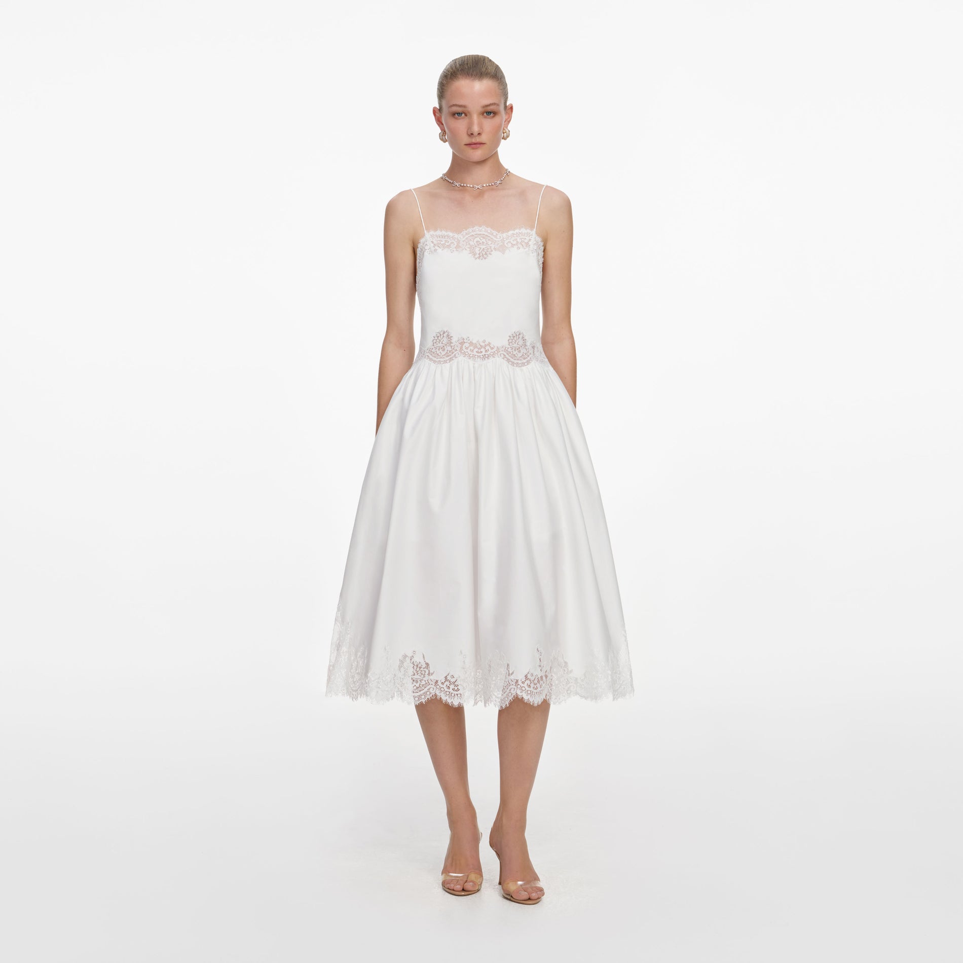 Front view of a woman wearing the White Cotton Lace Trim Midi Dress