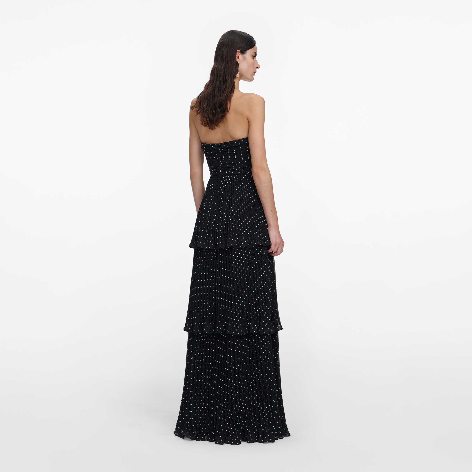 Back view of a woman wearing the Black Polka Dot Tiered Maxi Dress