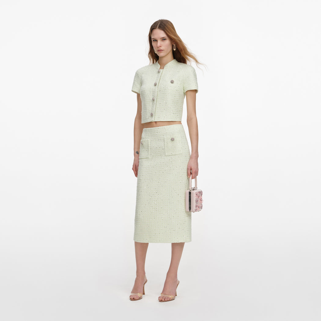 Side view of a woman wearing the Lime Boucle Midi Skirt