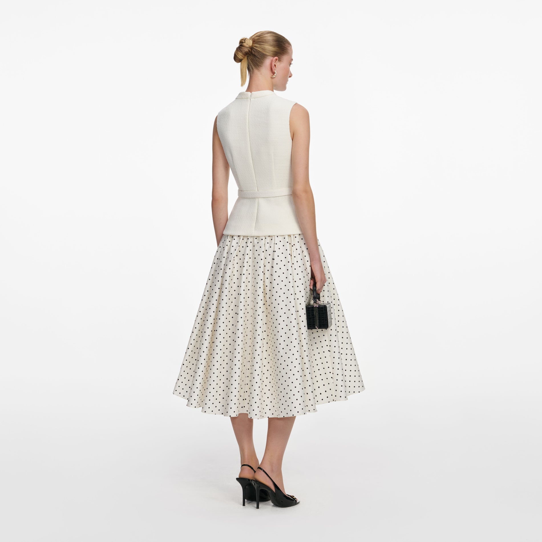 Back view of a woman wearing the Cream Boucle Polka Dot Midi Dress