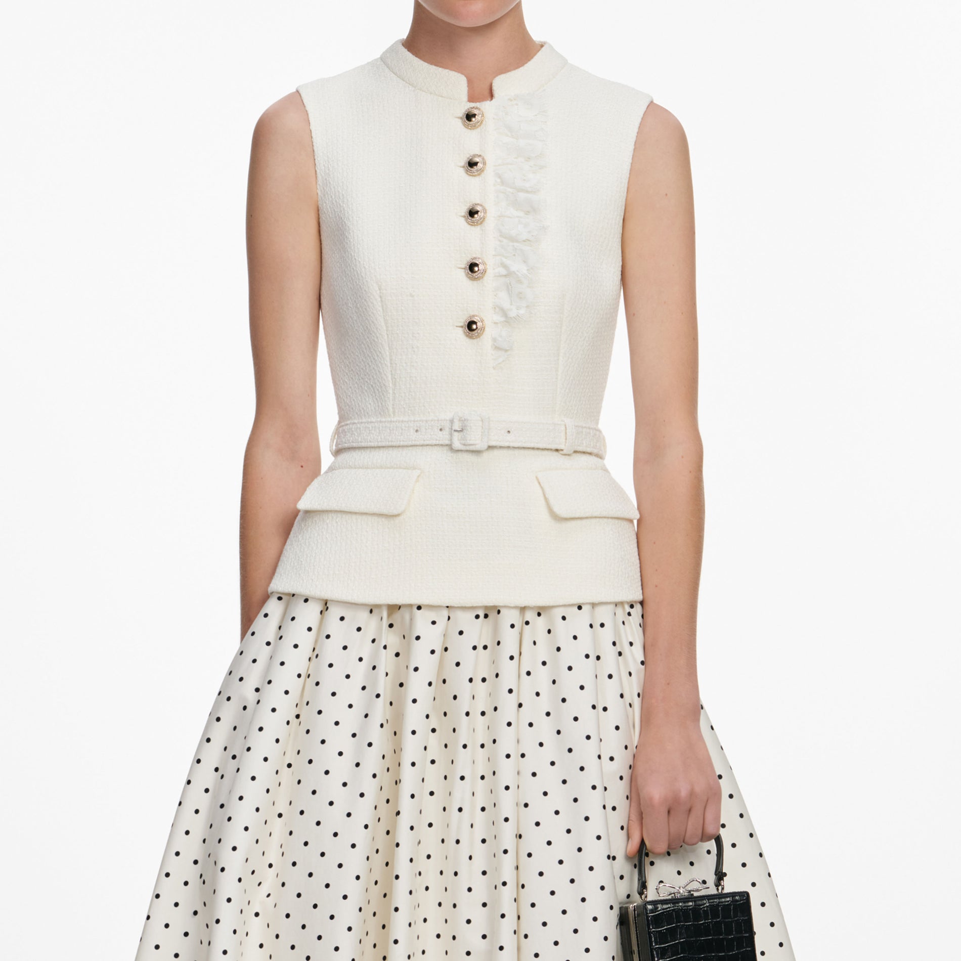 A close up of a woman wearing the Cream Boucle Polka Dot Midi Dress
