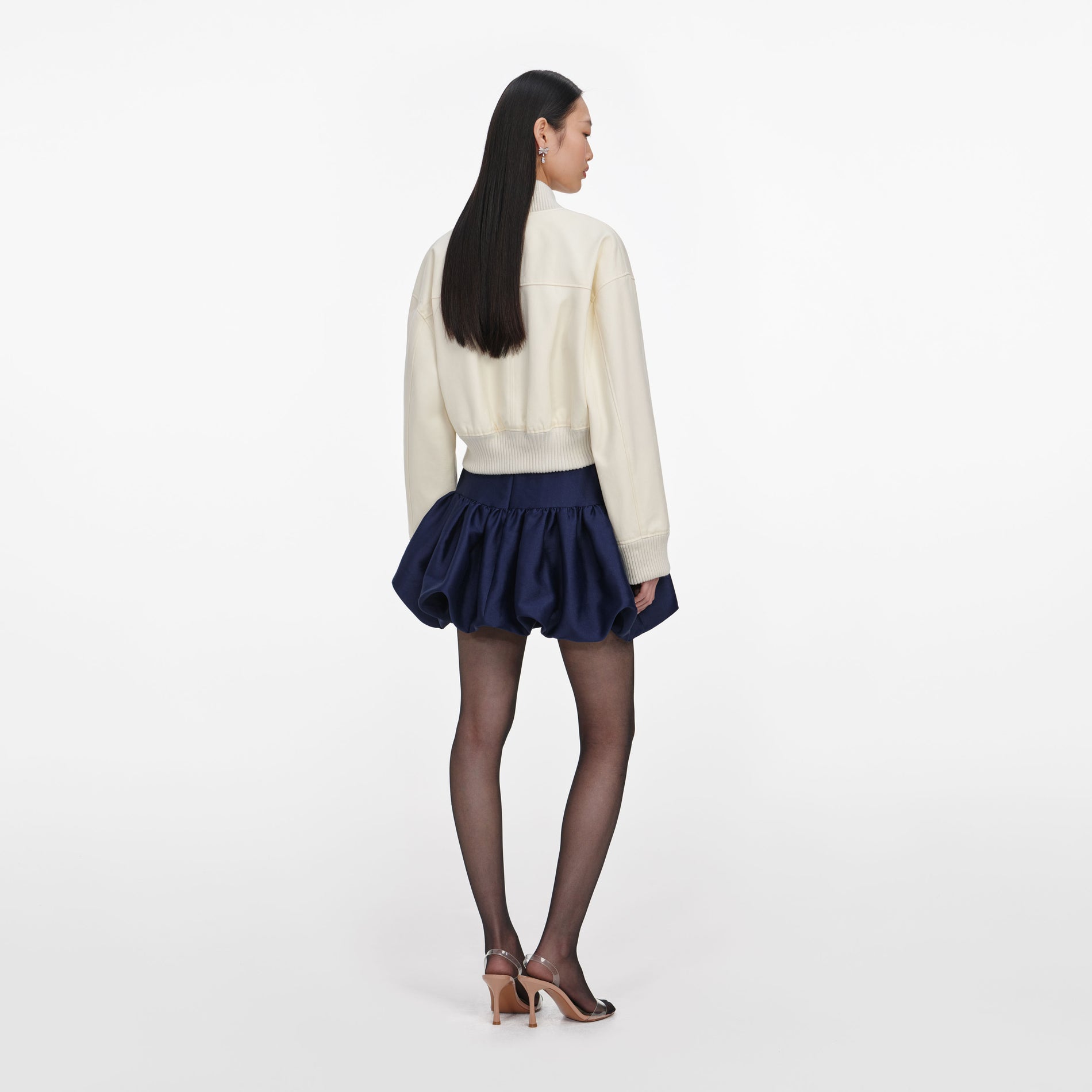Back view of a woman wearing the Cream Cotton Canvas Jacket