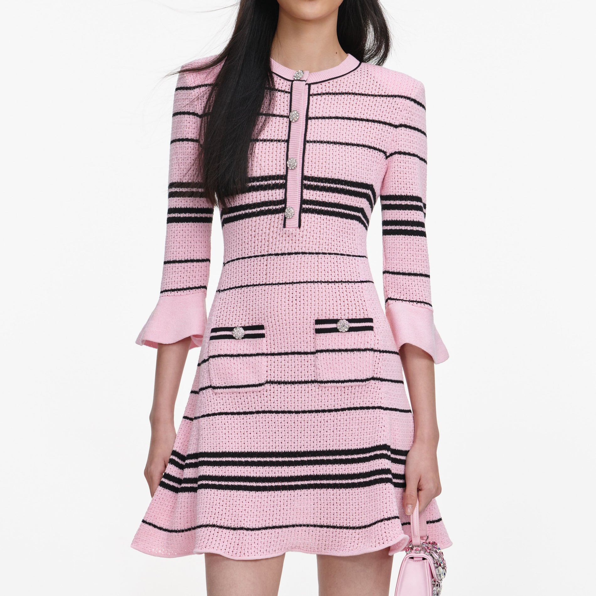 A close up of a woman wearing the Pink Stripe Knit Mini Dress