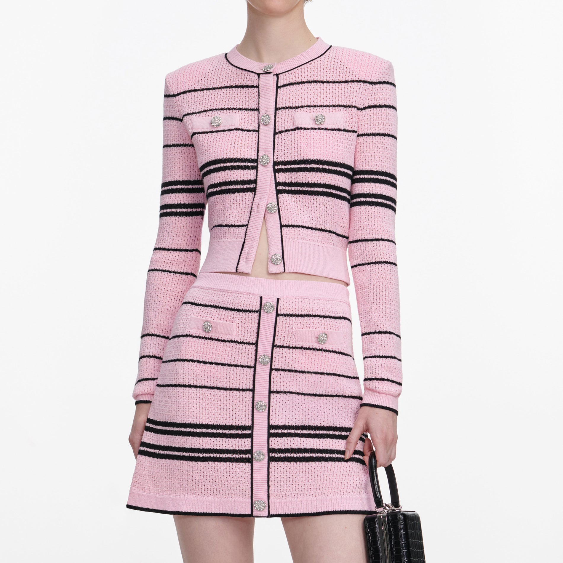 A close up of a woman wearing the Pink Stripe Knit Mini Skirt