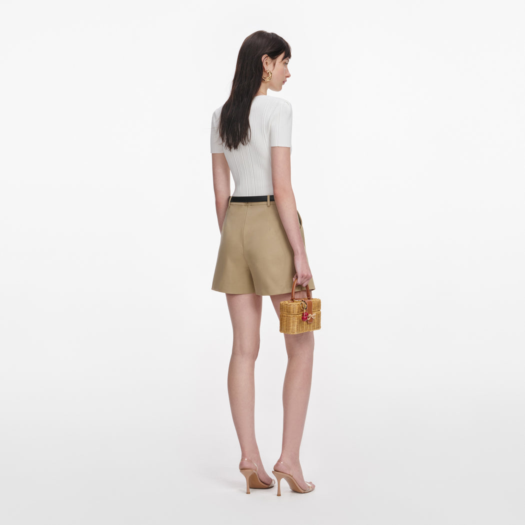 Back view of a woman wearing the Beige Cotton Skort