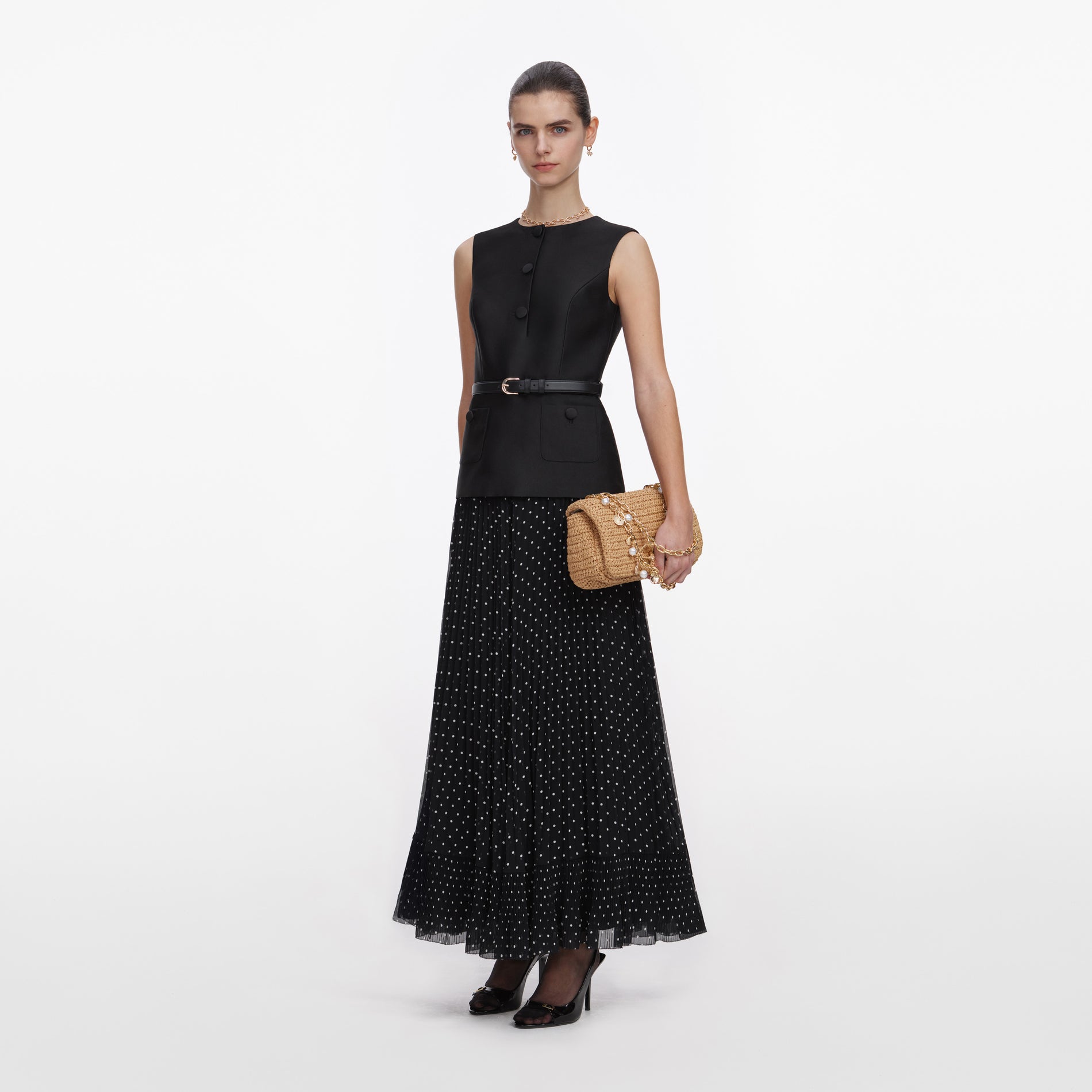 Side view of a woman wearing the Black Taffeta Polka Dot Midi Dress