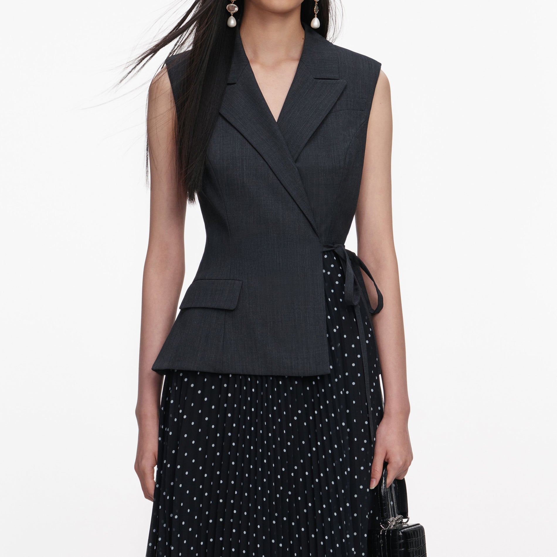 A close up of a woman wearing the Grey Tailored Polka Dot Midi Dress