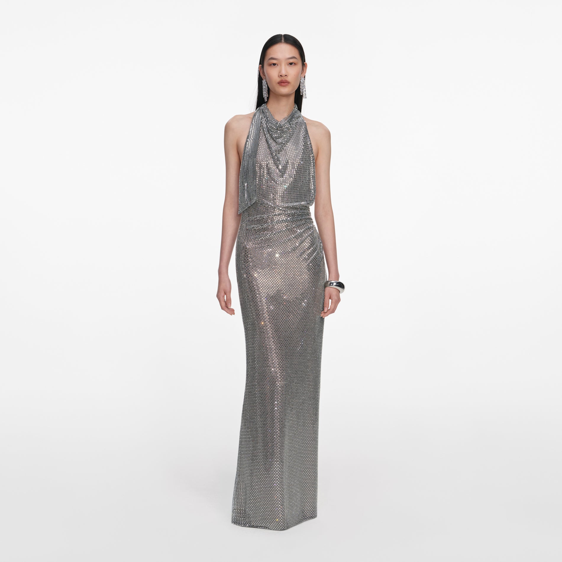Front view of a woman wearing the Grey Rhinestone Drape Maxi Dress