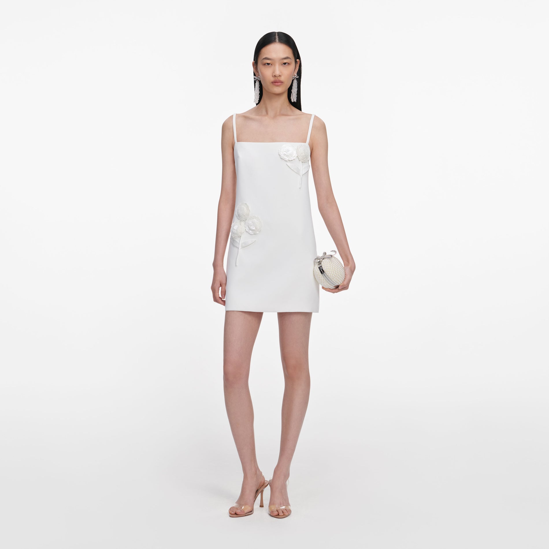 Front view of a woman wearing the White Crepe 3D Sequin Flower Mini Dress