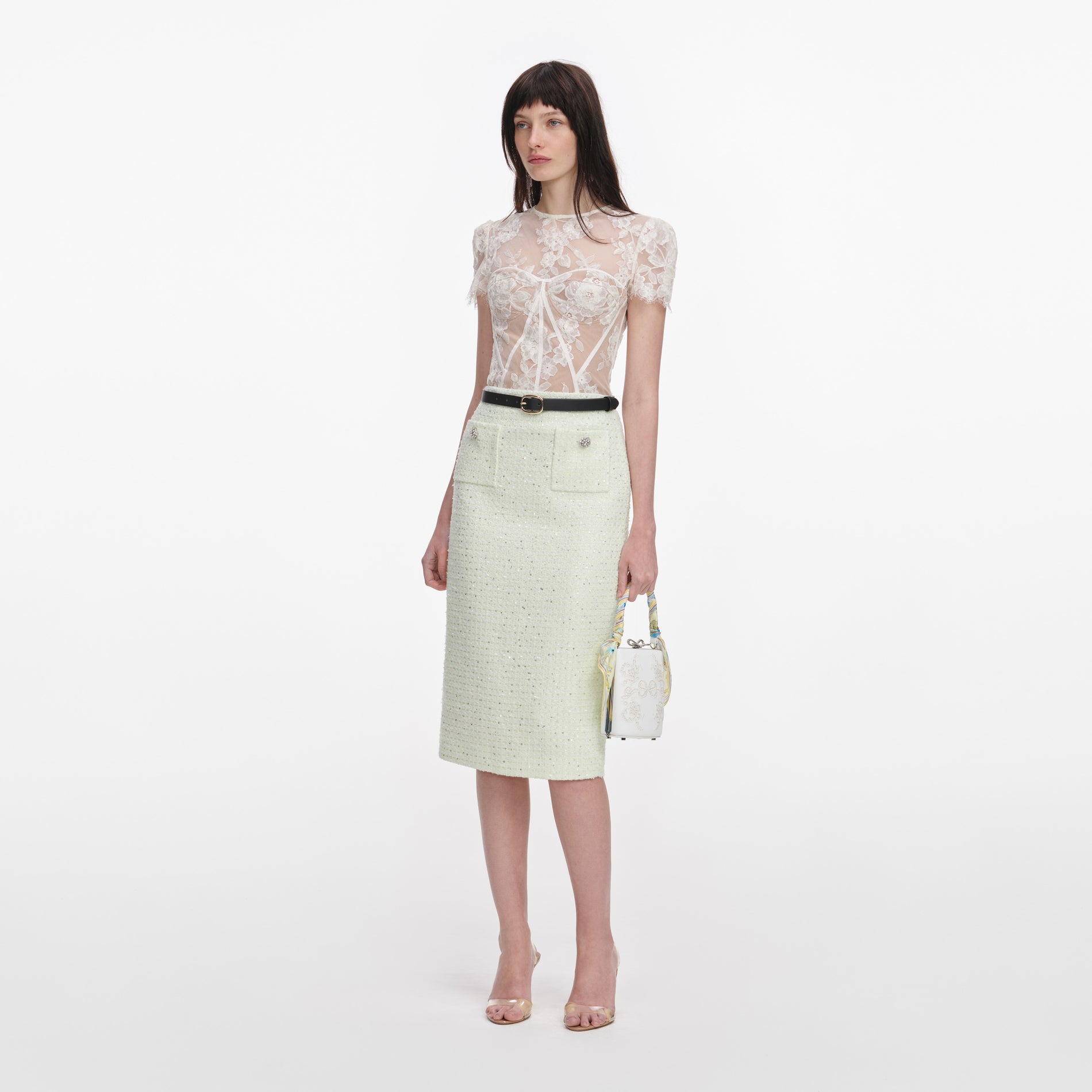 Side view of a woman wearing the White Sequin Lace Top