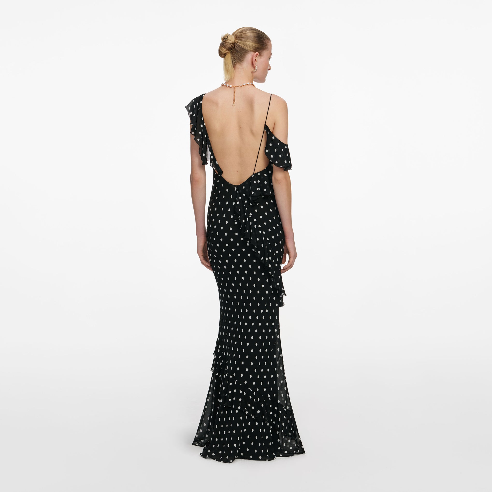Back view of a woman wearing the Black Polka Dot Georgette Maxi Dress