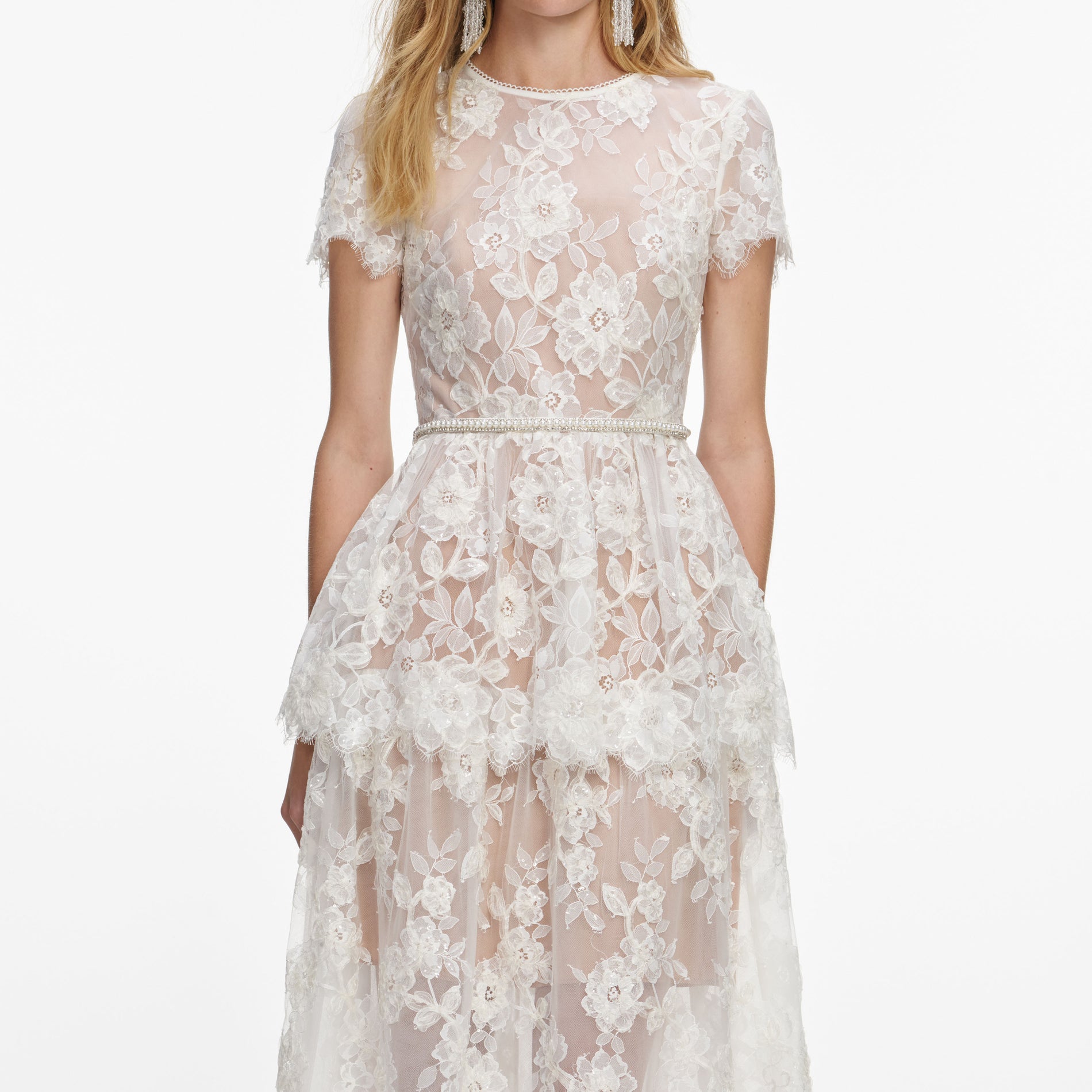 A close up of a woman wearing the White Sequin Lace Tiered Maxi Dress