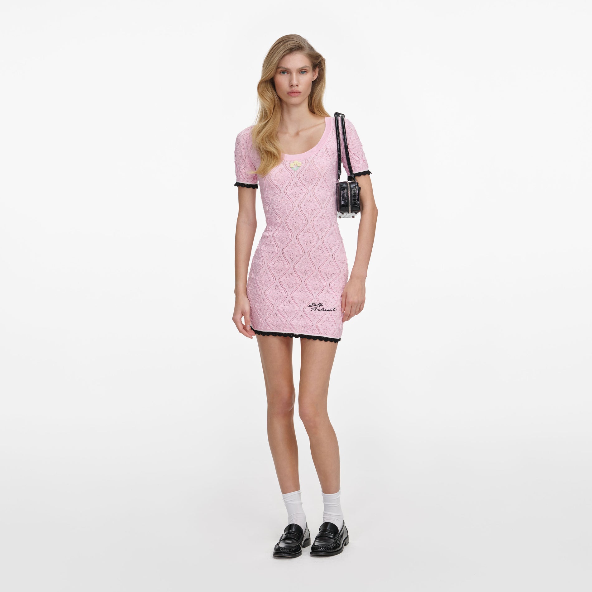Front view of a woman wearing the Pink Pointelle Knit Mini Dress