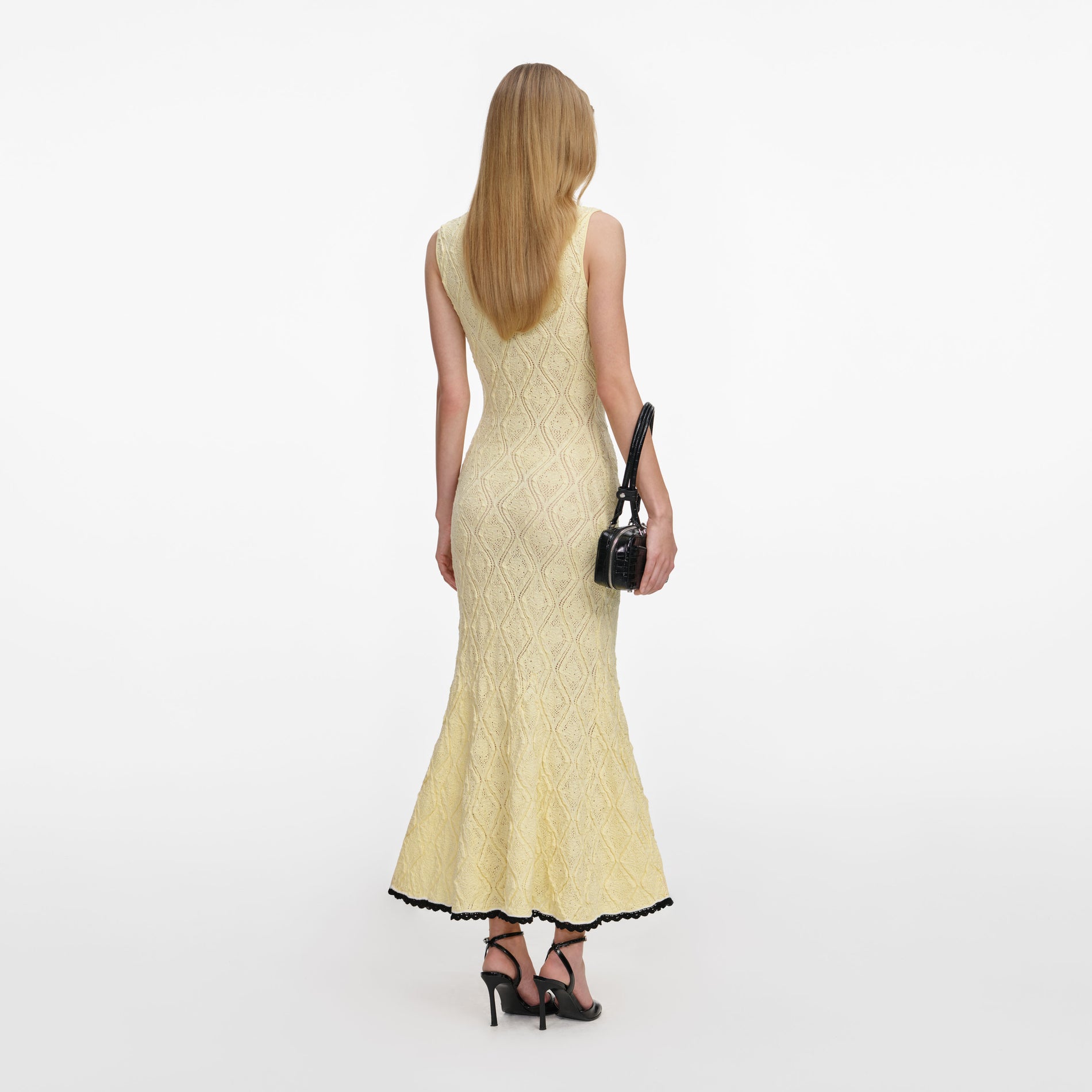 Back view of a woman wearing the Yellow Pointelle Knit Midi Dress