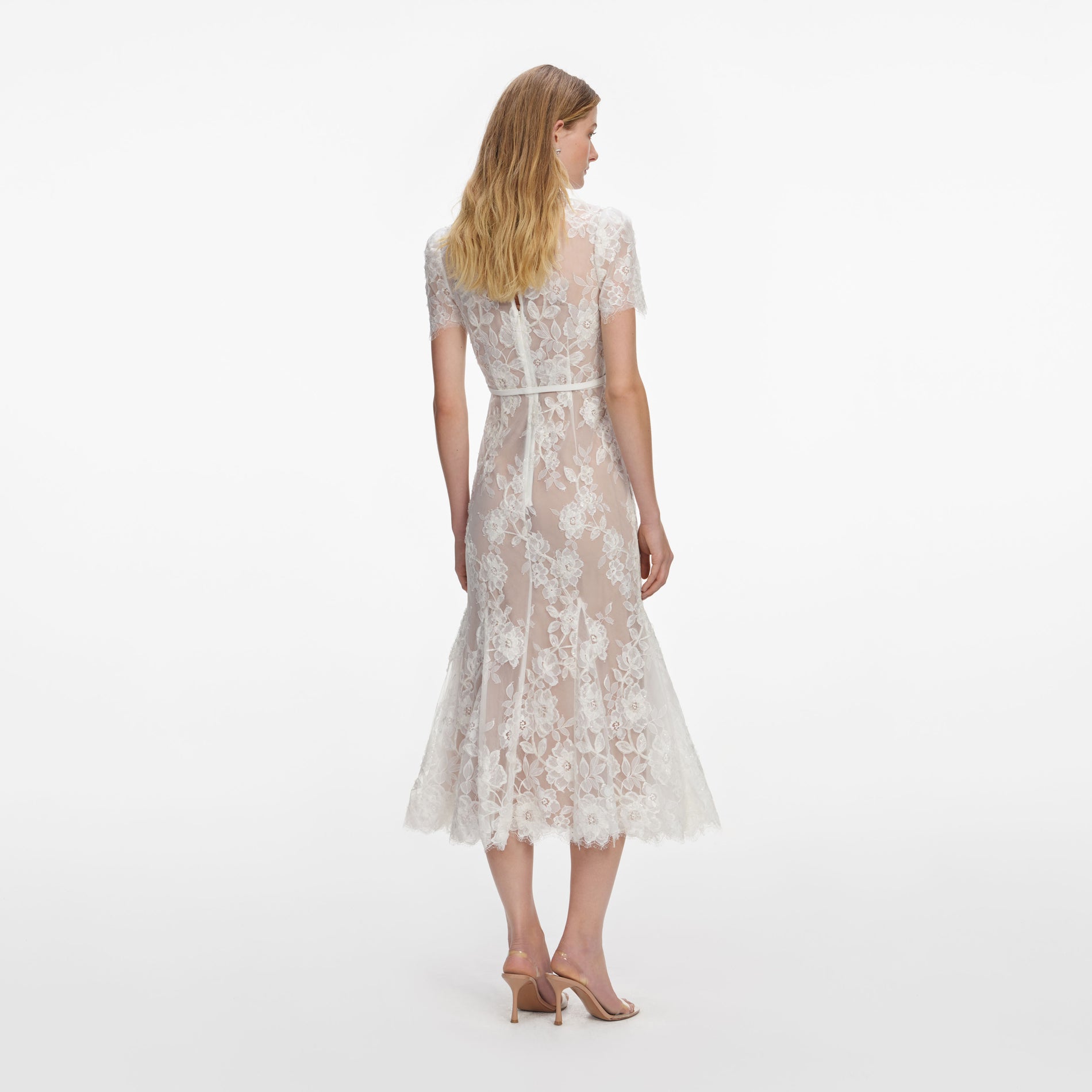 Back view of a woman wearing the White Sequin Lace Midi Dress