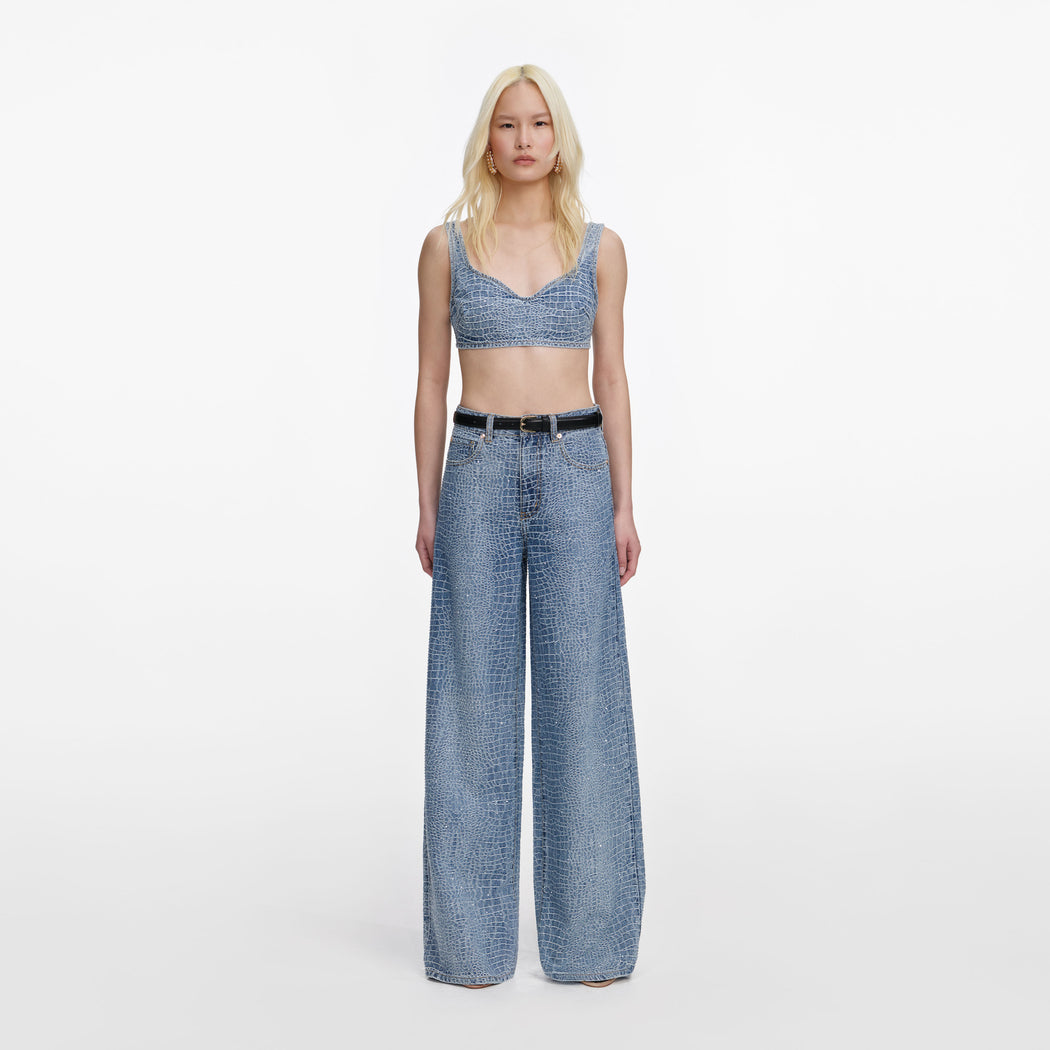 A close up of a woman wearing the Rhinestone Croc Effect Denim Bralette