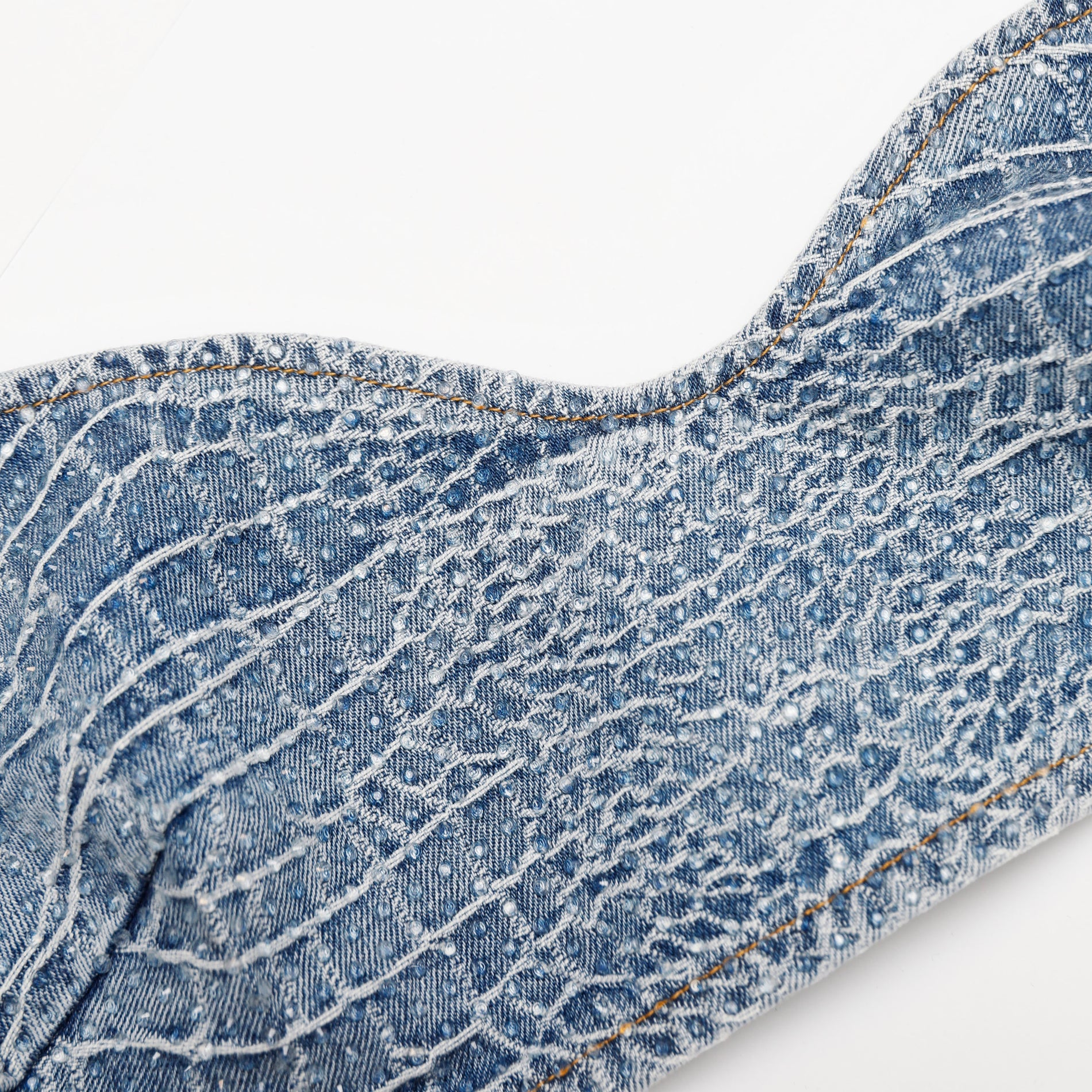 A close up of the fabric for the Rhinestone Croc Effect Denim Bralette