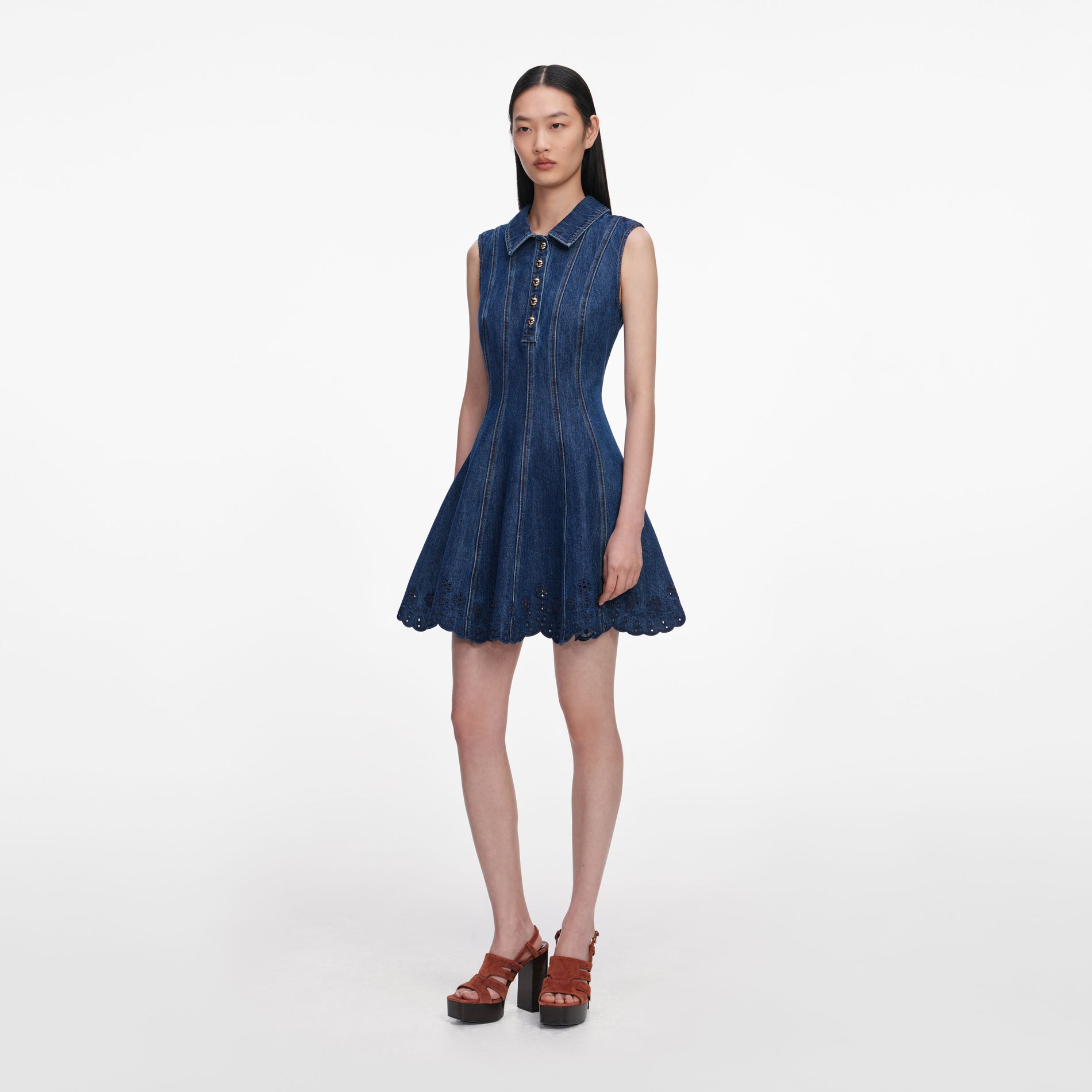 Side view of a woman wearing the Denim Broderie Mini Dress