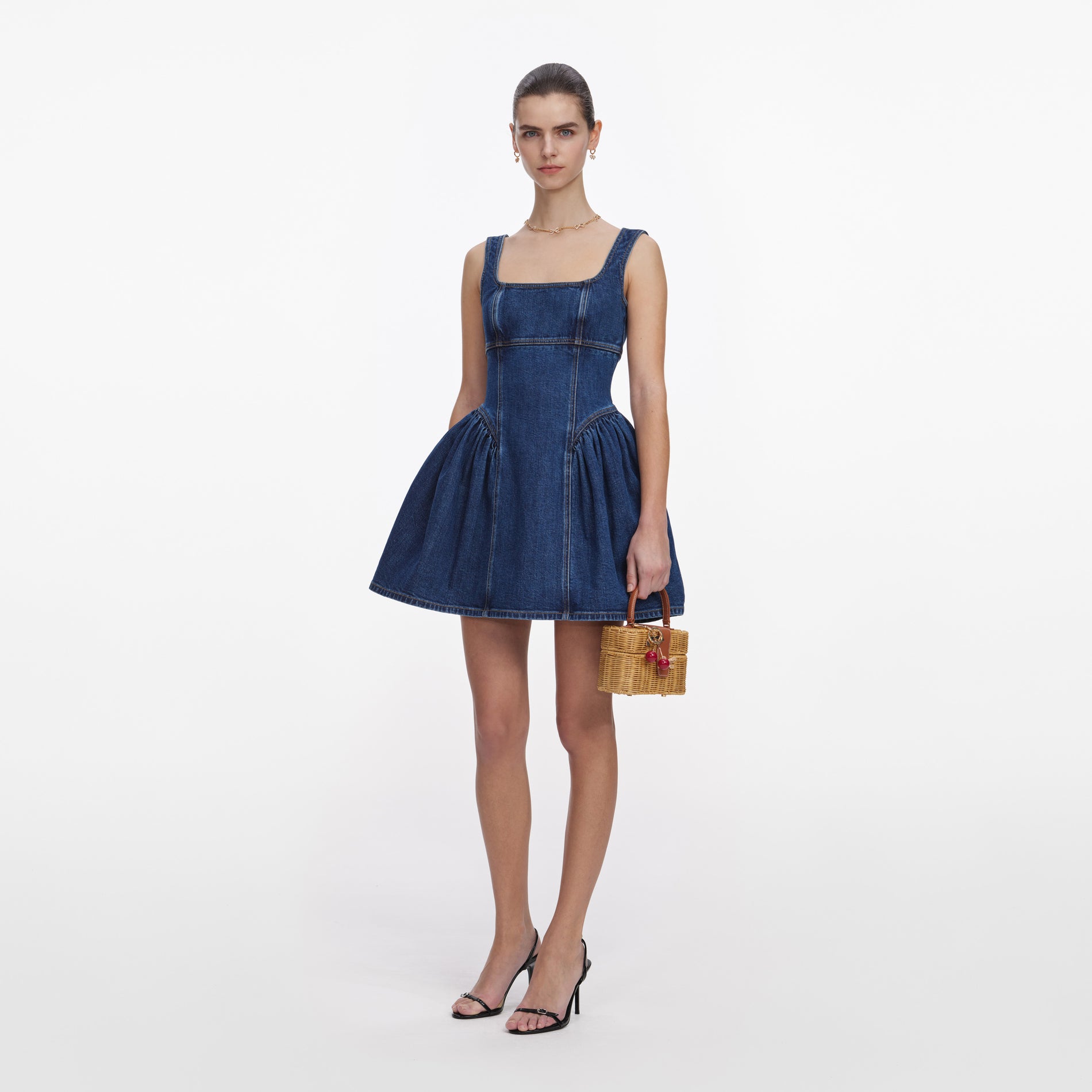 Side view of a woman wearing the Denim Mini Dress