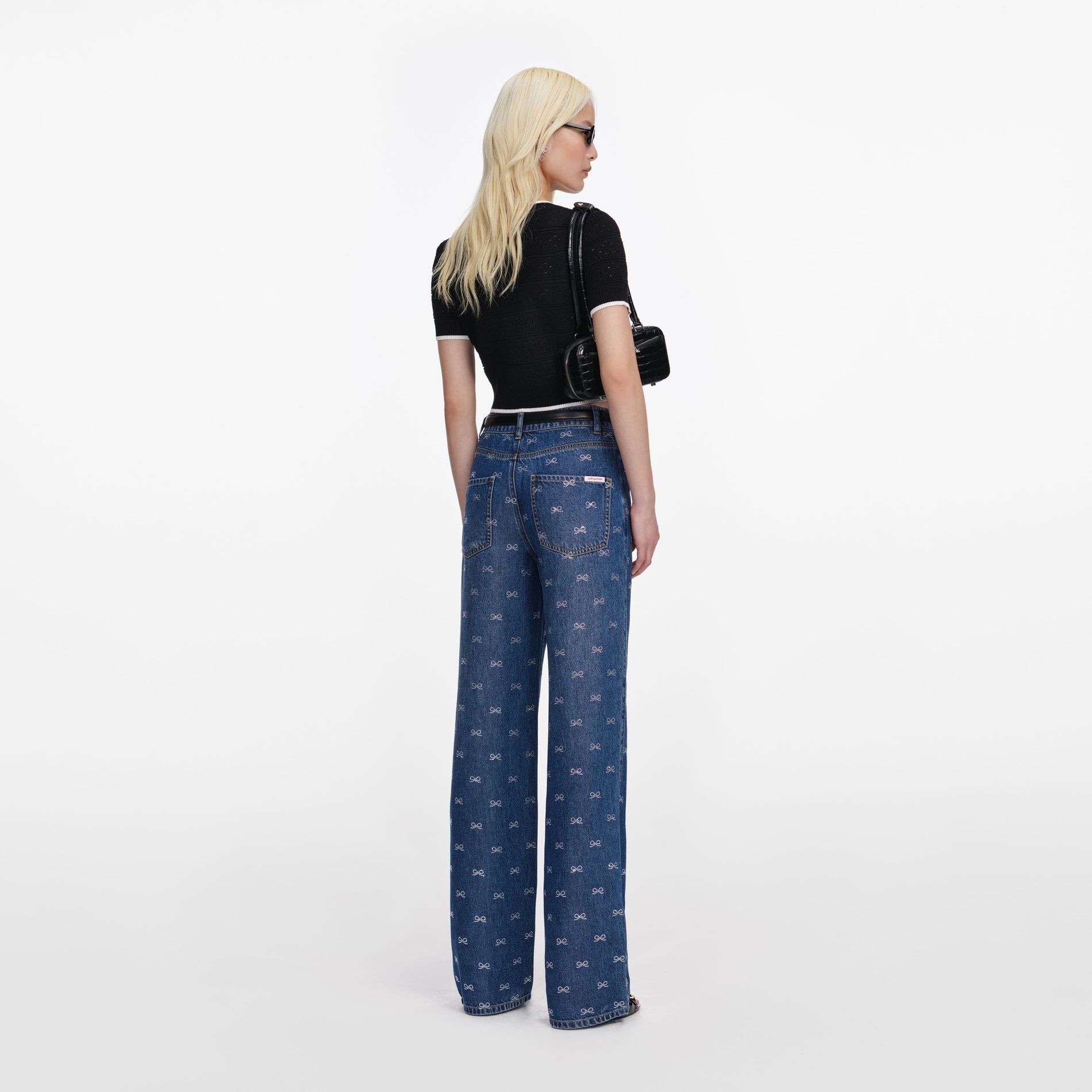 Back view of a woman wearing the Lightweight Bow Embellished Jeans