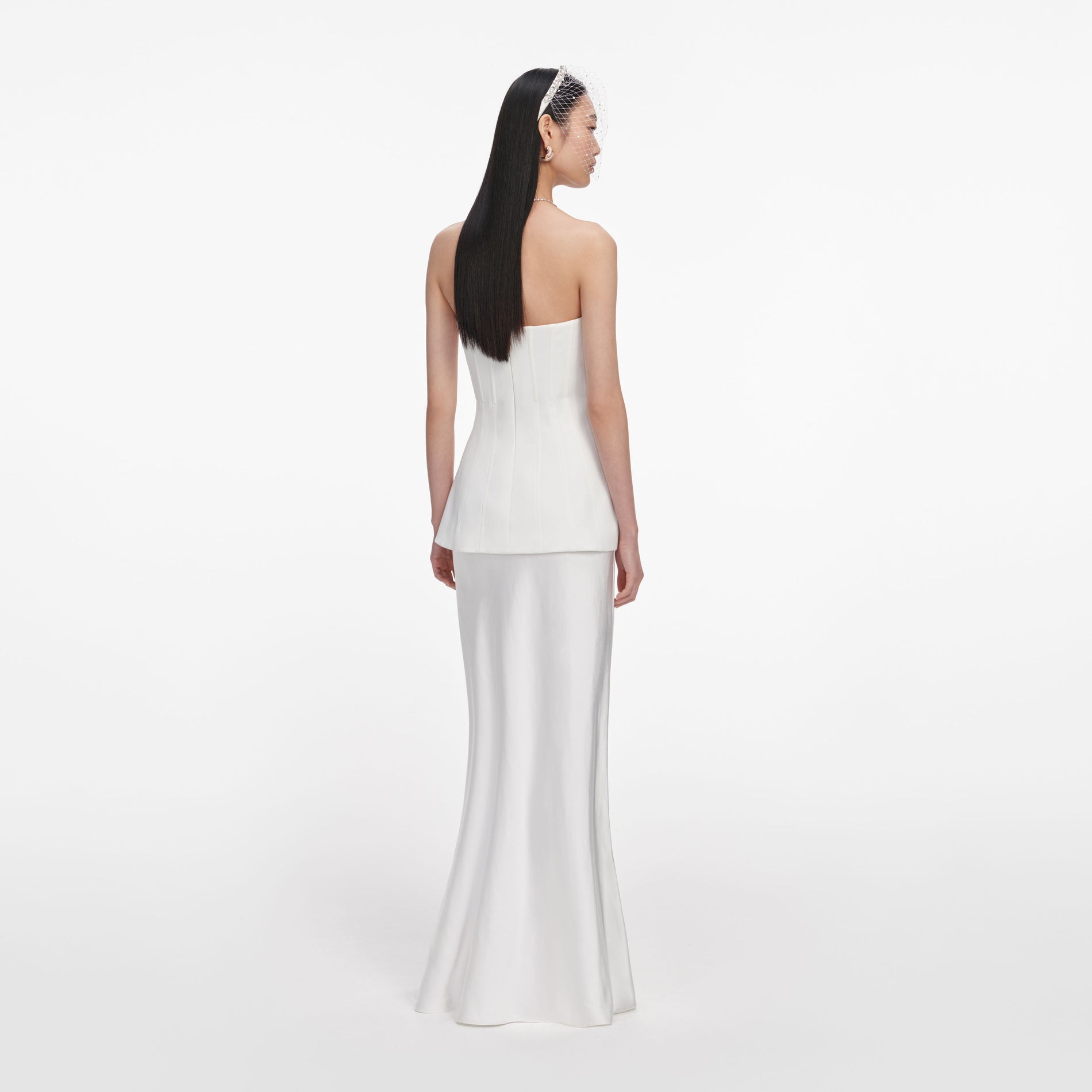 Back view of a woman wearing the White Bandeau Maxi Dress