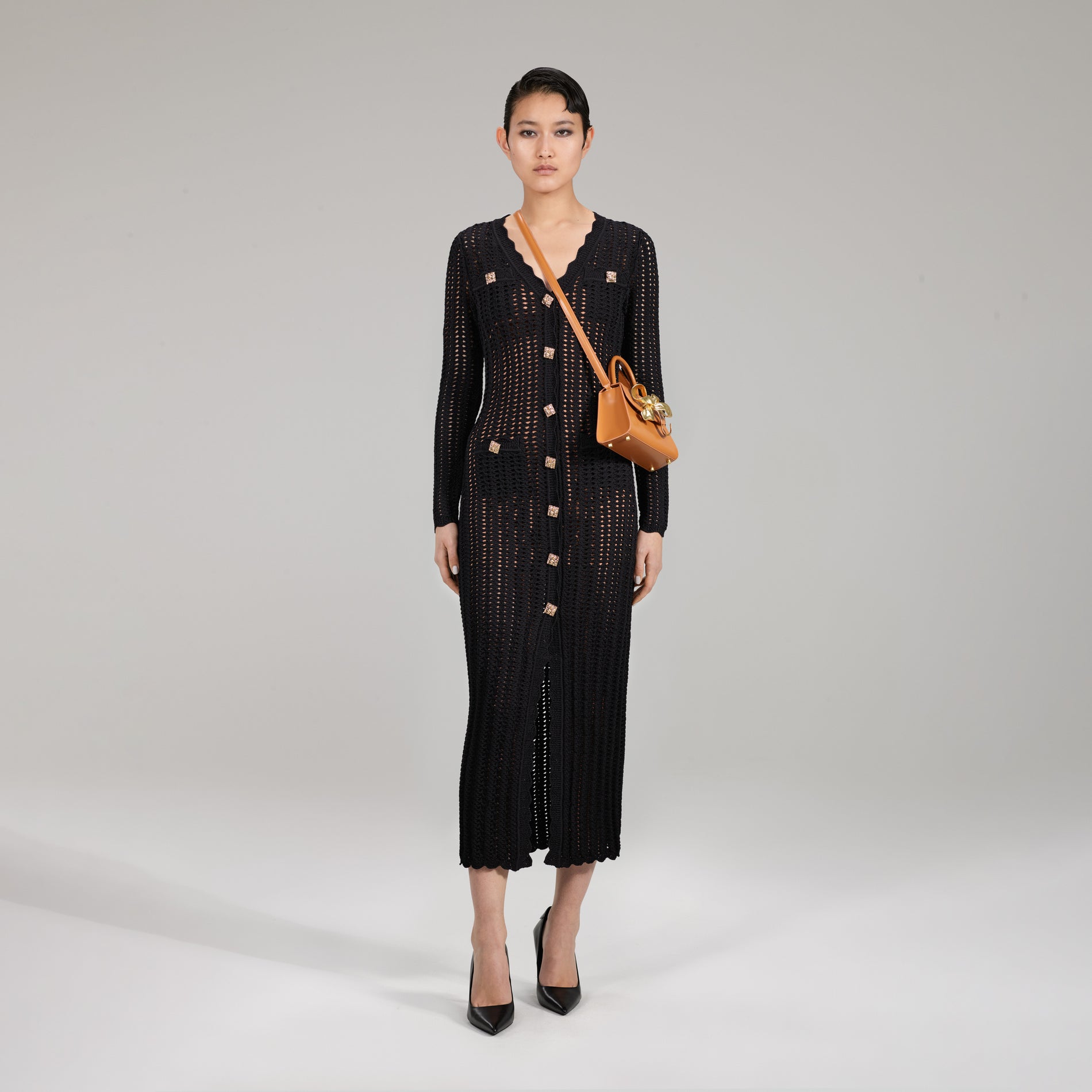 A woman wearing the Black Crochet Knit Dress