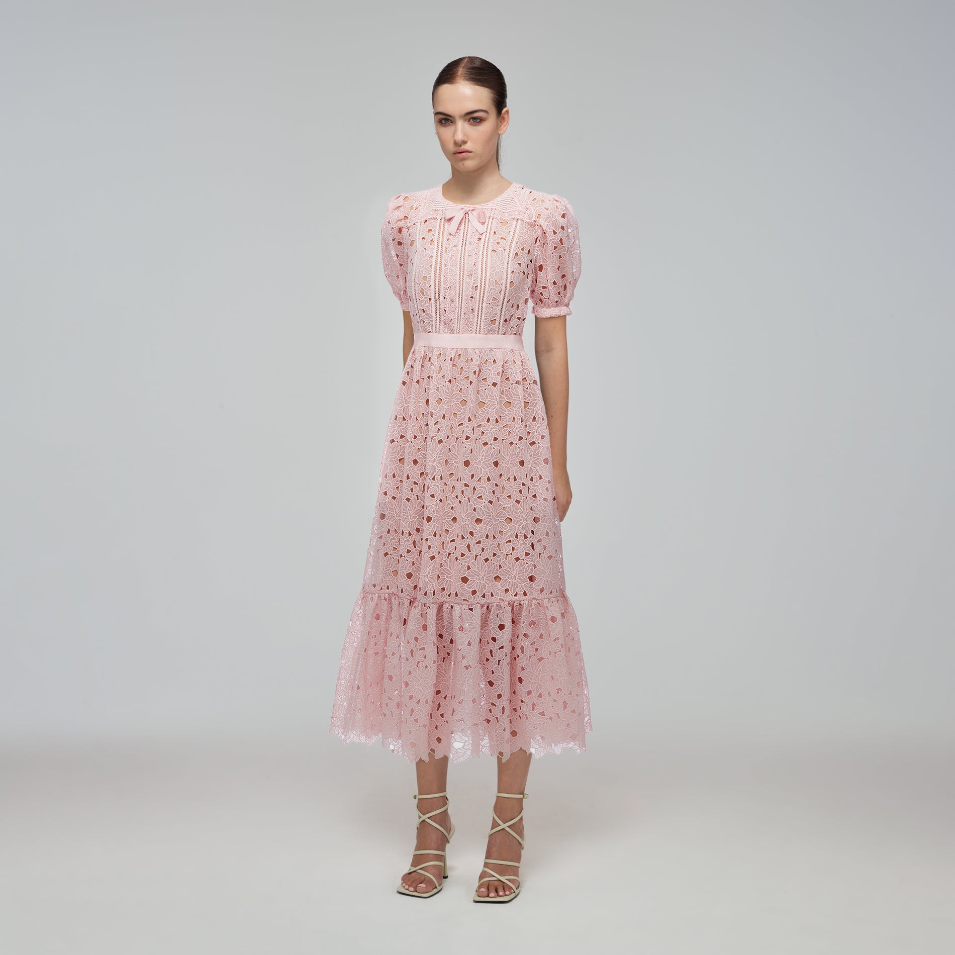 A woman wearing the Blush Guipure Midi Dress