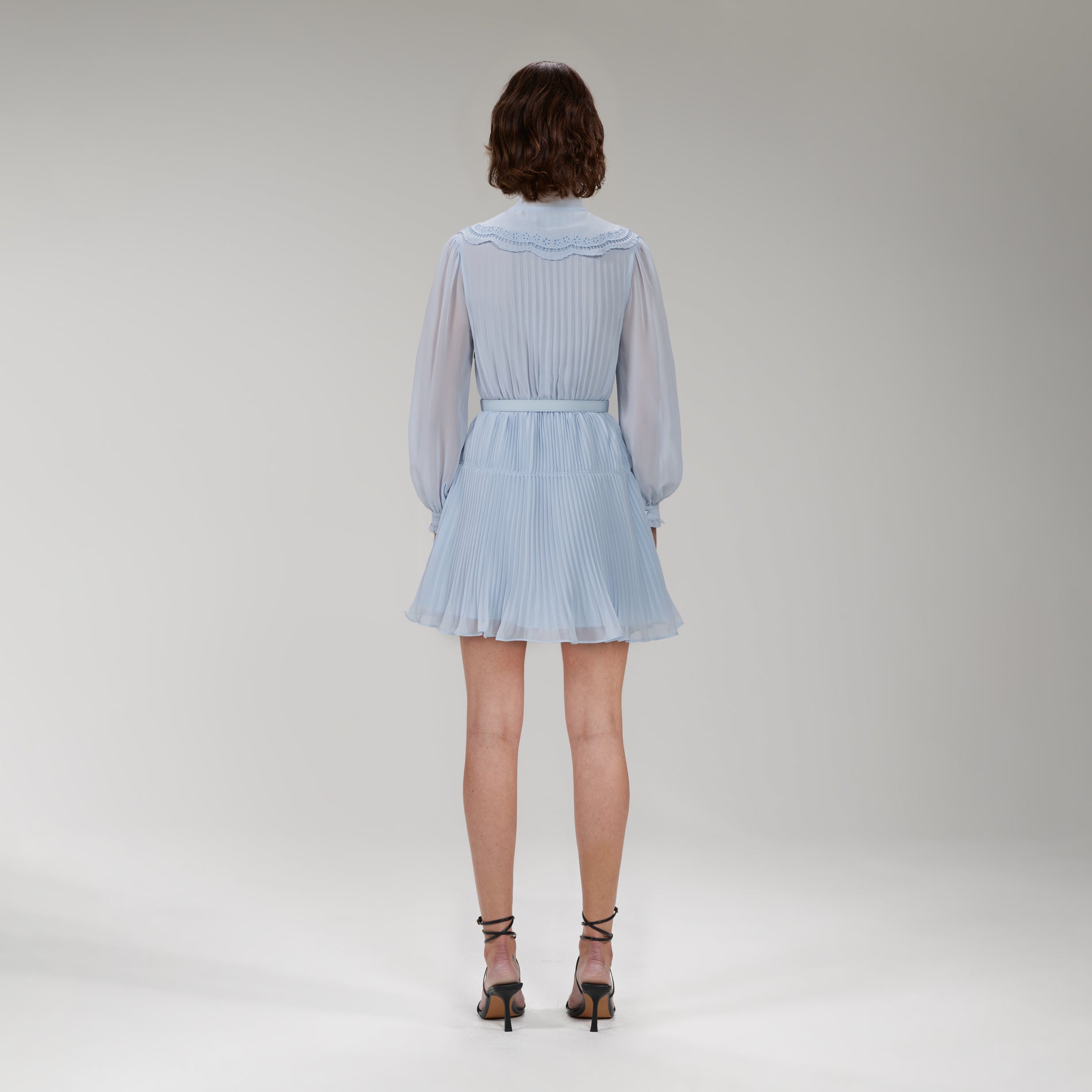 A woman wearing the Blue Broderie Collar Chiffon Mini Dress
